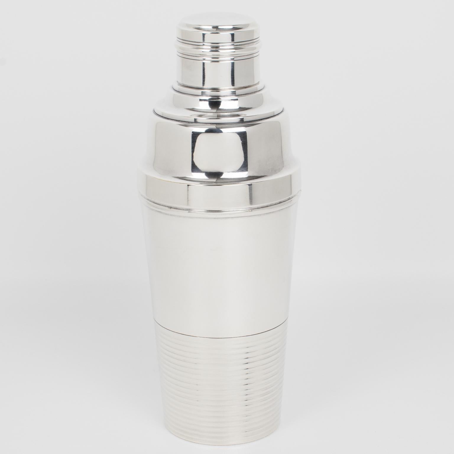 French silversmith Societe Parisienne d'Orfevrerie (SPO), Paris, crafted this lovely Art Deco silver plate cylindrical cocktail or Martini Shaker in the 1940s. The three-sectioned cocktail shaker has a removable cap and a filter strainer. This