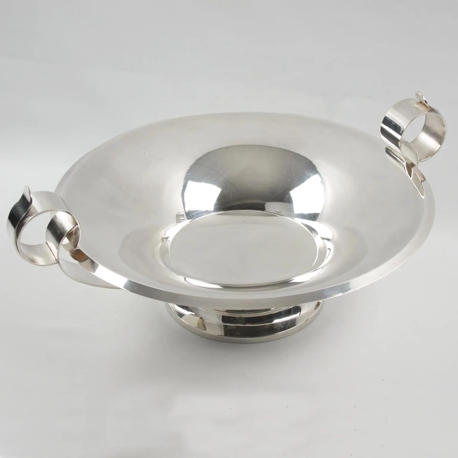 This elegant Art Deco polished silver plate pedestal bowl, centerpiece, or serving bowl was designed by Silversmith Francois Frionnet, Paris, in the 1930s. The modernist design with a round stepped bottom boasts a funnel-shaped dish with a flat base