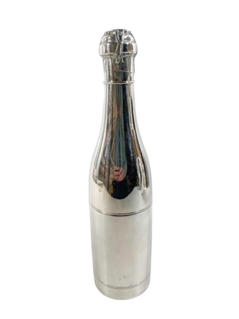 Silver plate cigar humidor in the form of a champagne bottle with a threaded opening just below the shoulder for airtight cigar storage and another just below the cork for matches. The neck of the bottle engraved with leaves and the lower section
