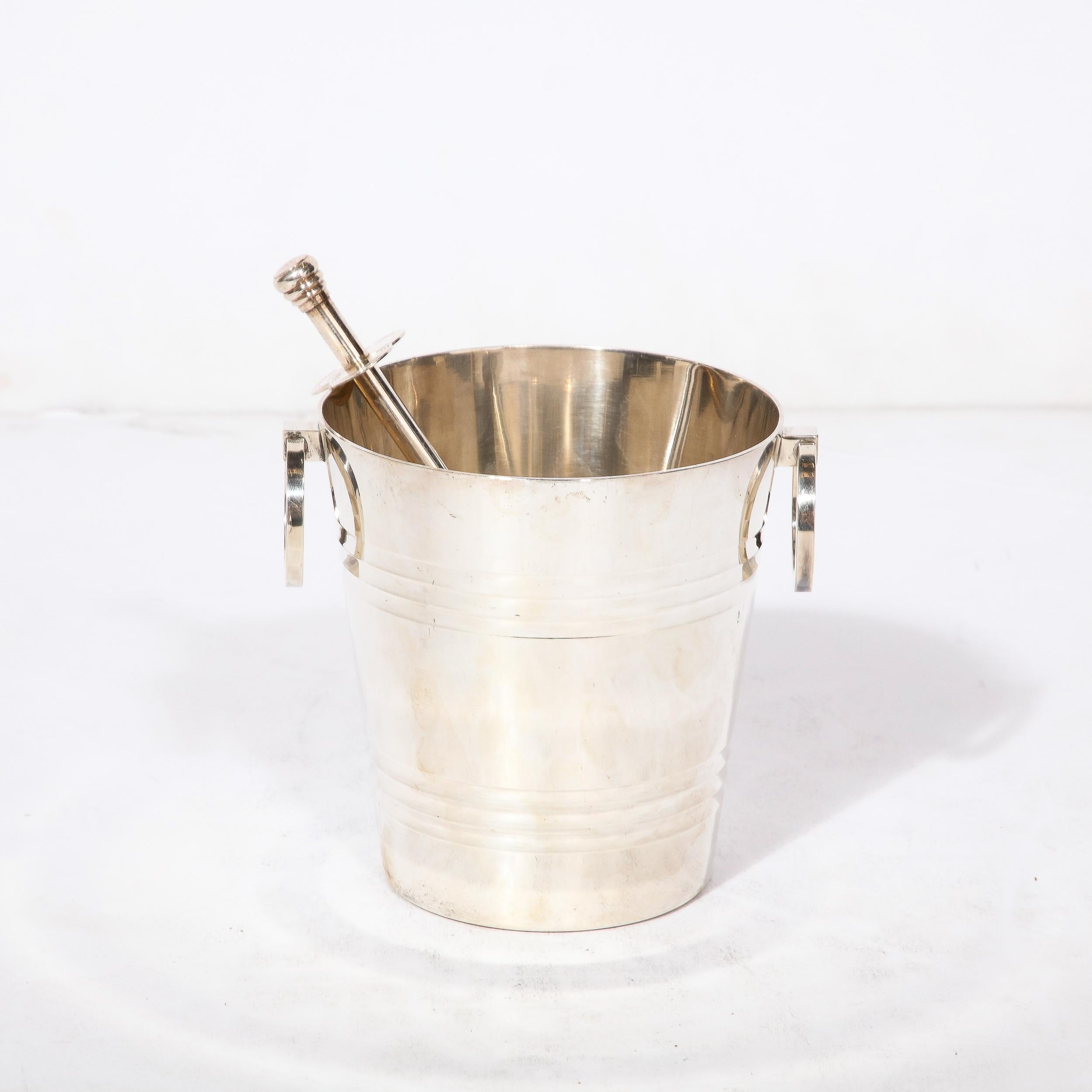 This Art deco  SilverPlate  Ice Bucket originates from France, Circa 1940. Featuring beautiful streamlined detailing throughout the design with moments of radiating spaced grooves on the body of the piece, the handles are geometric and minimal rings