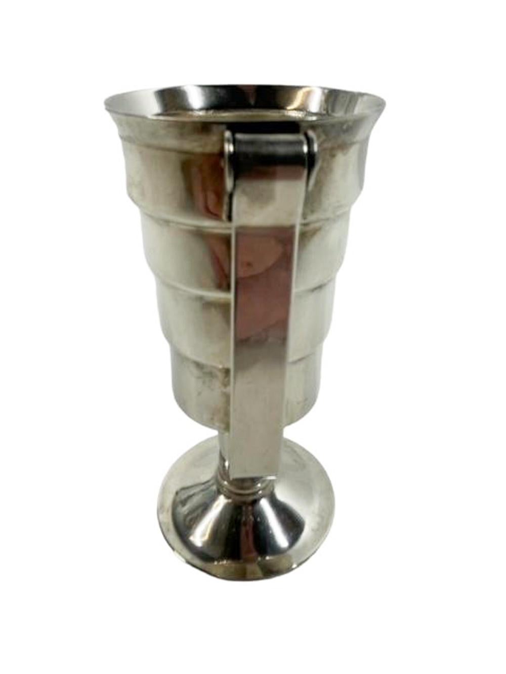 Art Deco silver plate mechanical spirit measure / jigger (squeeze the handle to release the contents). Stepped cylindrical cup on footed stemmed base and calibrated for 1/2oz to 2oz. When filled to desired level, hold over the glass or shaker and