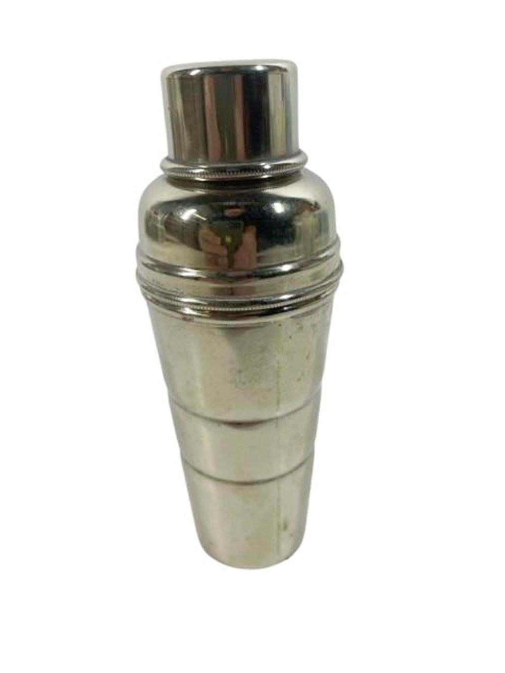 Art Ceco silver plate spirit measure / jigger of cobbler type cocktail shaker form in three parts. The bottom section with molded rings and volume measures and the two part lid/cap formed as a funnel for filling bitters bottles or flasks. Marked