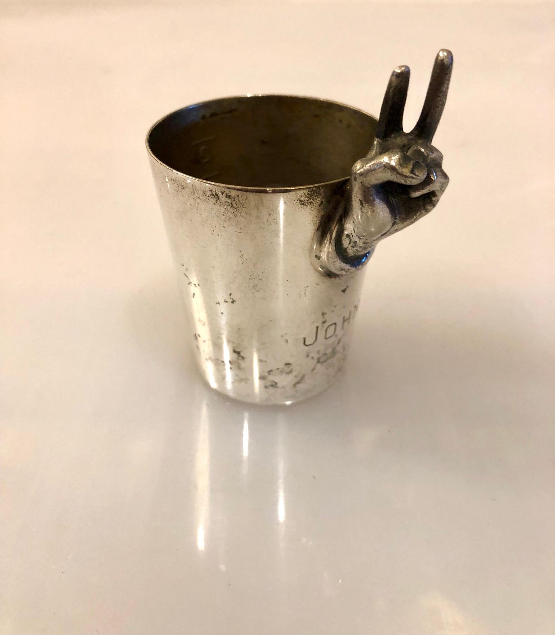 Unique polished silver plate shot cup with peace sign, bridal gift signed and dated 1964 and stamped Jhon in the front, manufactured by Napier.