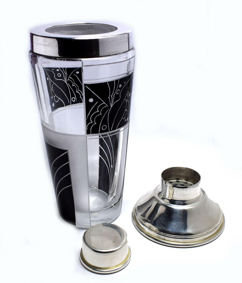 Fabulous 1930s cocktail Shaker with a hall marked silver plated lid and heavy glass base. Wonderful geometric enamelling to the body of the Shaker with little to no wear at all. Ideal for anyone making up items to go with their barware or cocktail