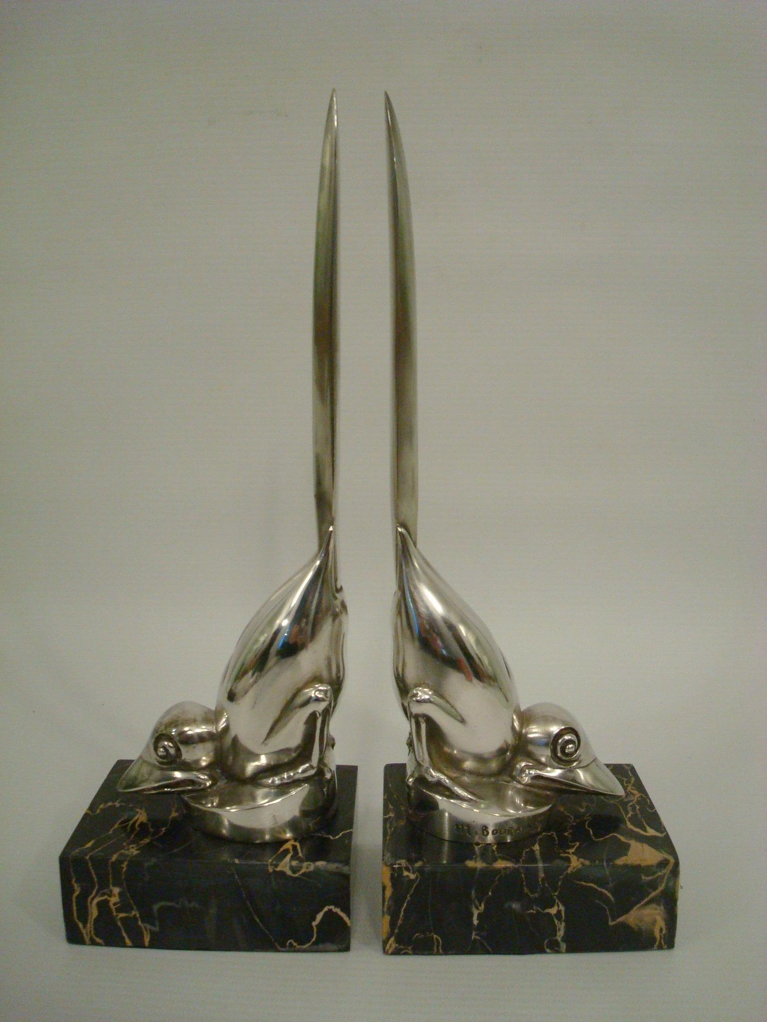 Pair of Art Deco silvered bronze bird bookends. Silver plated bronze figures mounted over black and gold italian marble bases.
Both signed M. Bouraine and marked france.
Very clean lines sculptures. Very chic.