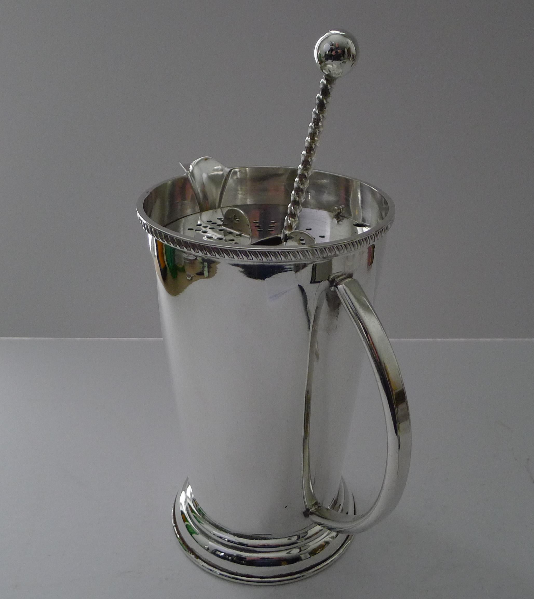 A magnificent vintage cocktail or Martini mixer by the well renowned, P H Vogel & Co. of Birmingham.

The jug has a removable strainer which fixes into the top of the jug and the two mounts are used to twist and open this strainer; these also act as