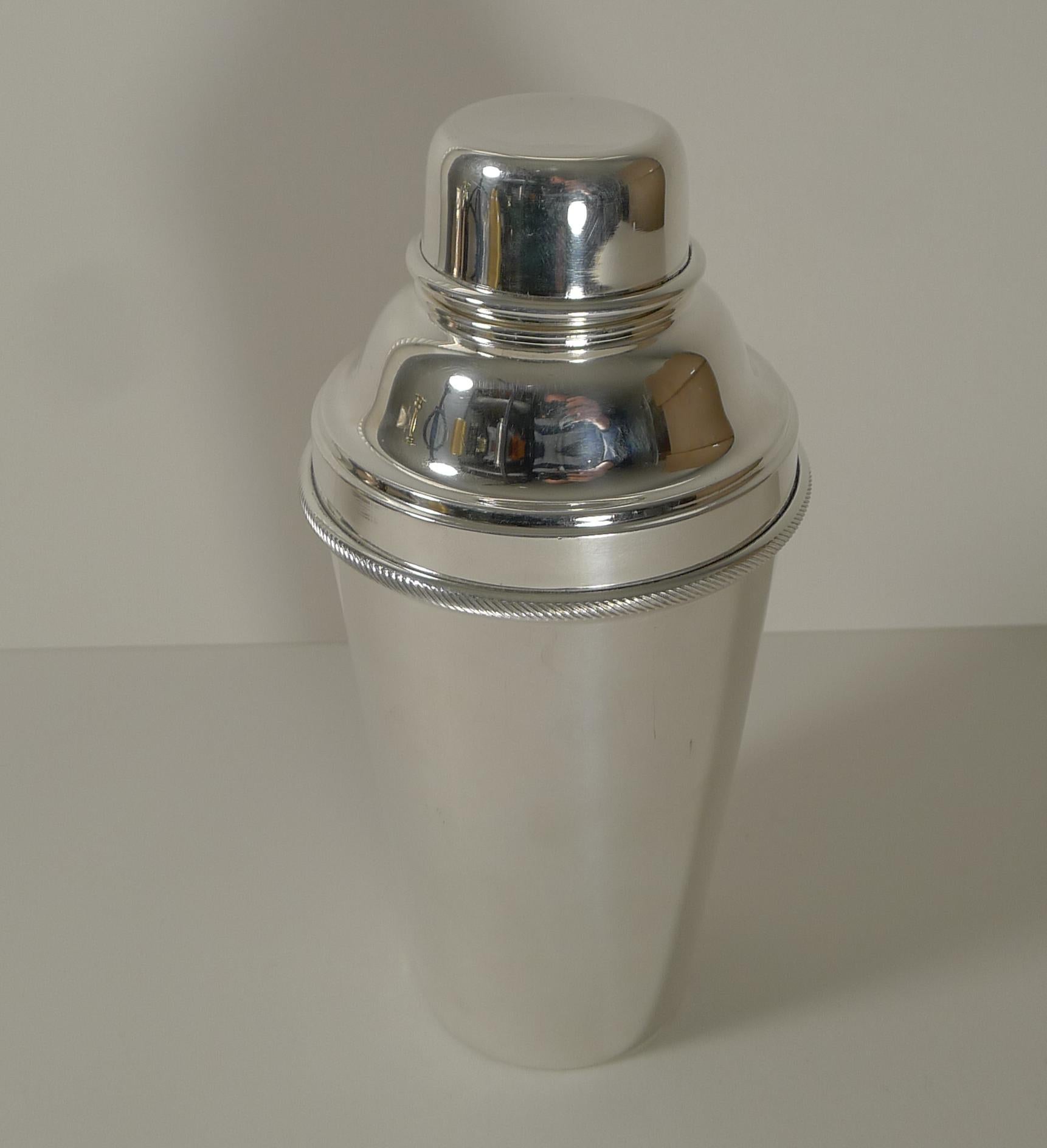 A lovely Art Deco silver plated cocktail shaker by well renowned silversmith, James Dixon and Sons. 

The top of the shaker reveals an integral ice breaker, always highly sought-after.

The underside is fully marked for James Dixon / Made In