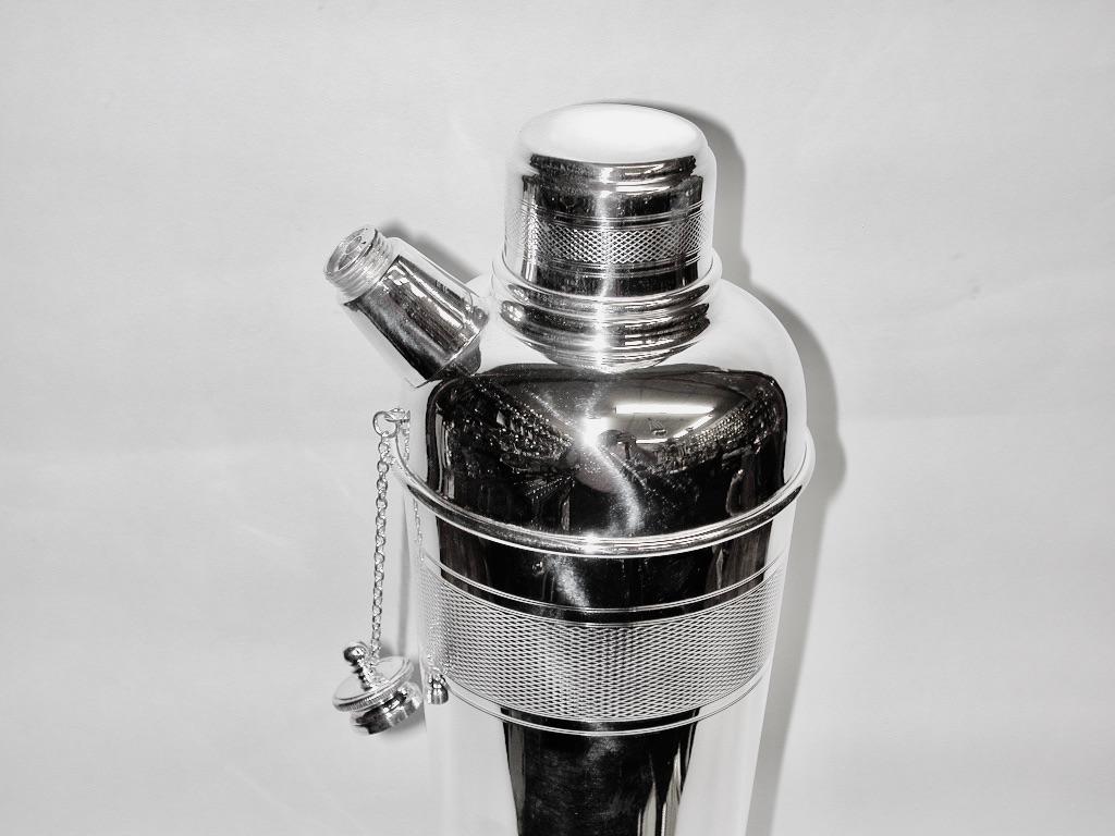 Art Deco silver plated cocktail shaker, dated circa 1930, P H Vogel and Co
Good quality partly engine turned tall cocktail shaker with pourer made by the specialist barware manufacturer
PH Vogel & Co of Birmingham.
Inside the lid is a special