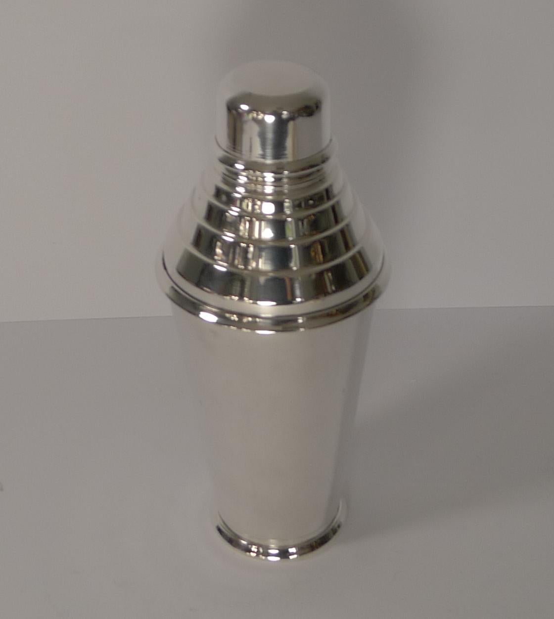 A fine English Art Deco cocktail shaker, silver plated and made for the luxury London retailer, Harrods. Fully signed on the underside 