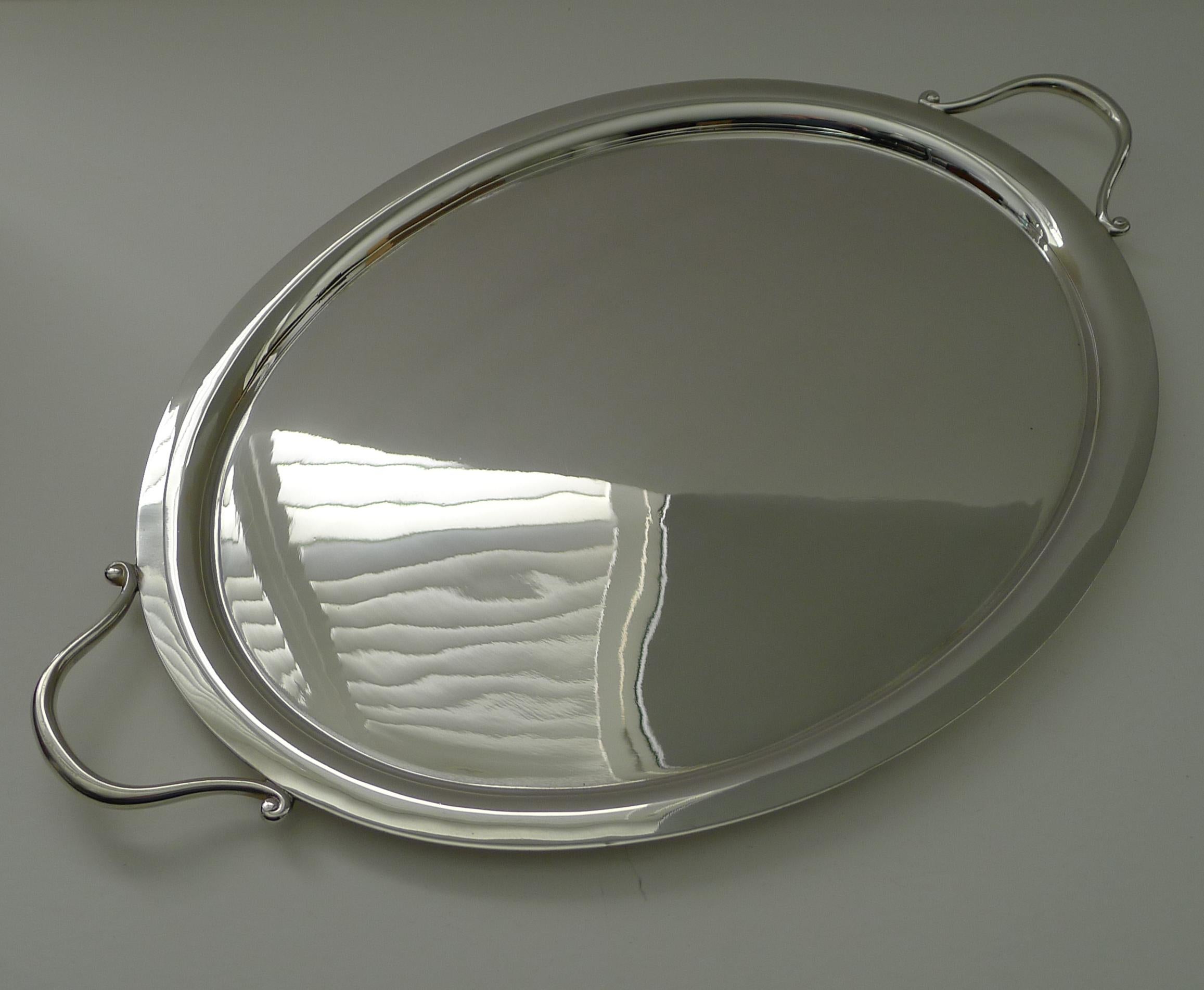 A very smart cocktail / serving tray in silver plate by the luxury silversmith / retailer, Asprey of Bond Street, London. Signed on the underside.

Of oval form with two handles. Just back from our silversmith's workshop where it has been