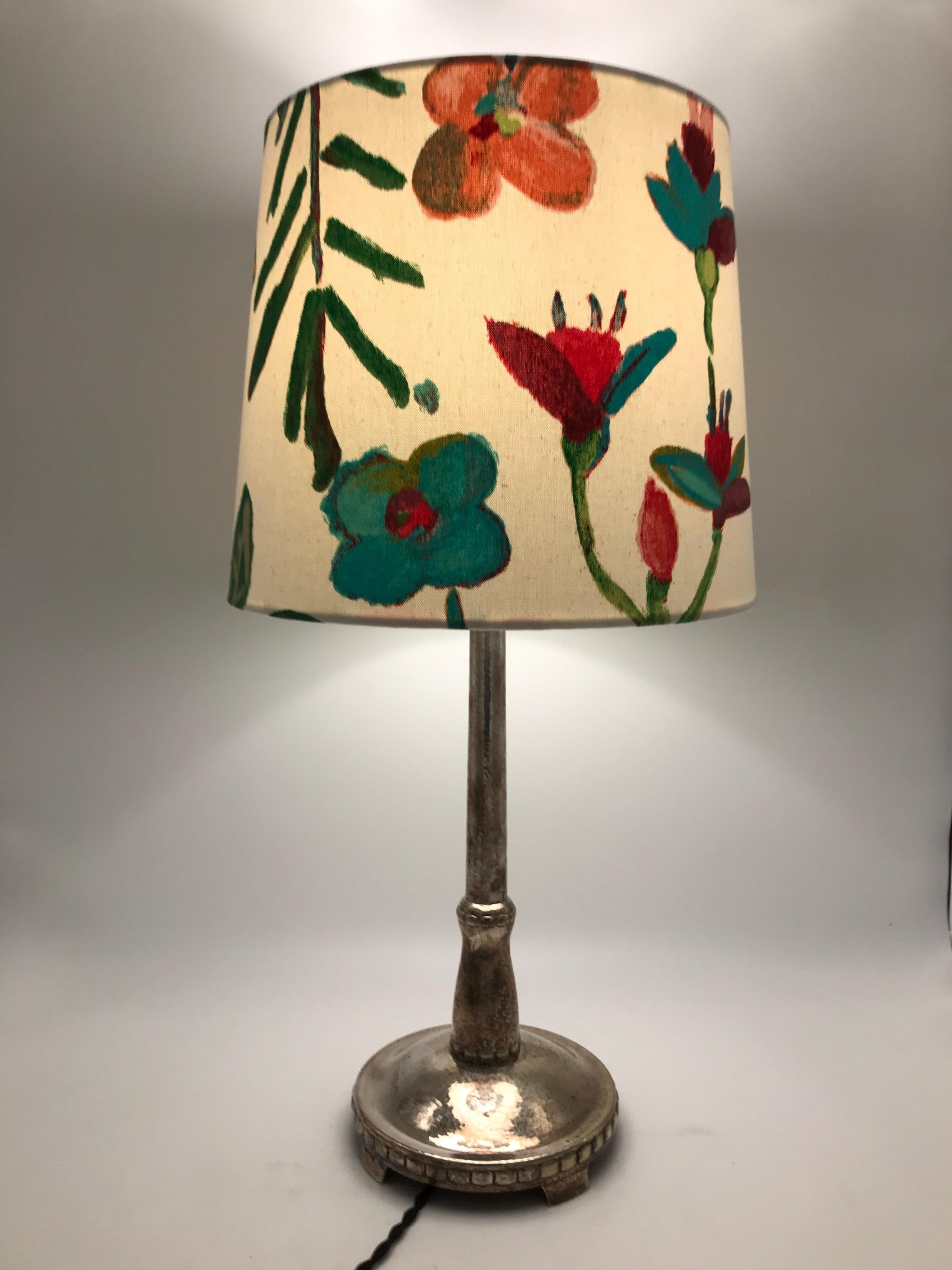 Art Deco silver plated table lamp with a limited edition ArtbyMaj lampshade. 
A very stylish table lamp in the manner of Georg Jensen. 
Rewired with an in-line on off switch. 
Can be fitted with an EU or US plug. 
A very attractive tarnish and