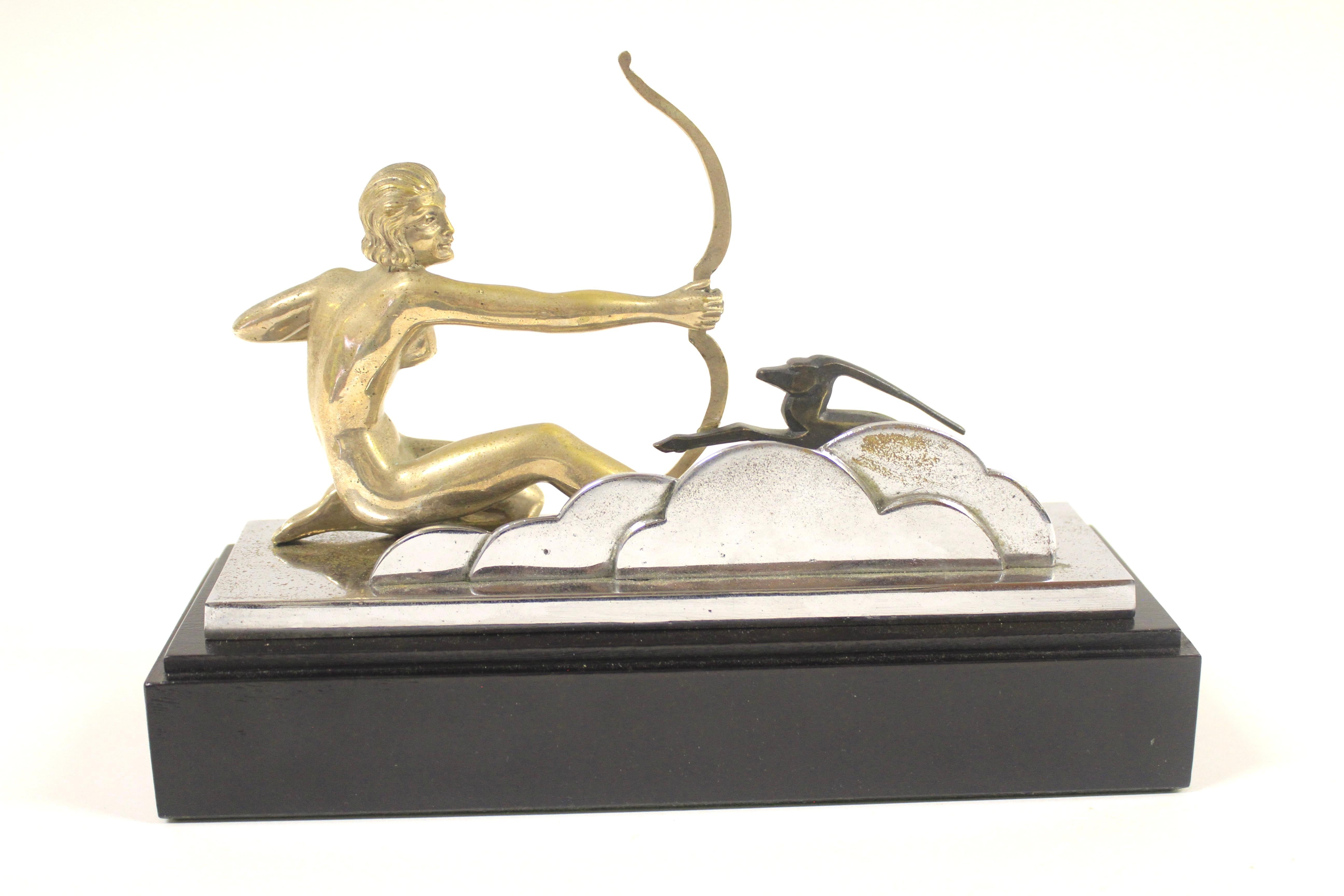 Art Deco Silver Plated Diana the Huntress Figure circa 1930s
Silver plated on Bronze, 
Sylized Bronze figure of a deer, 
Chrome Plated Base and Stylized Backround
[ some pitting to the chrome base] 
Mounted on Ebonised Hardwood stand
Green Baize on