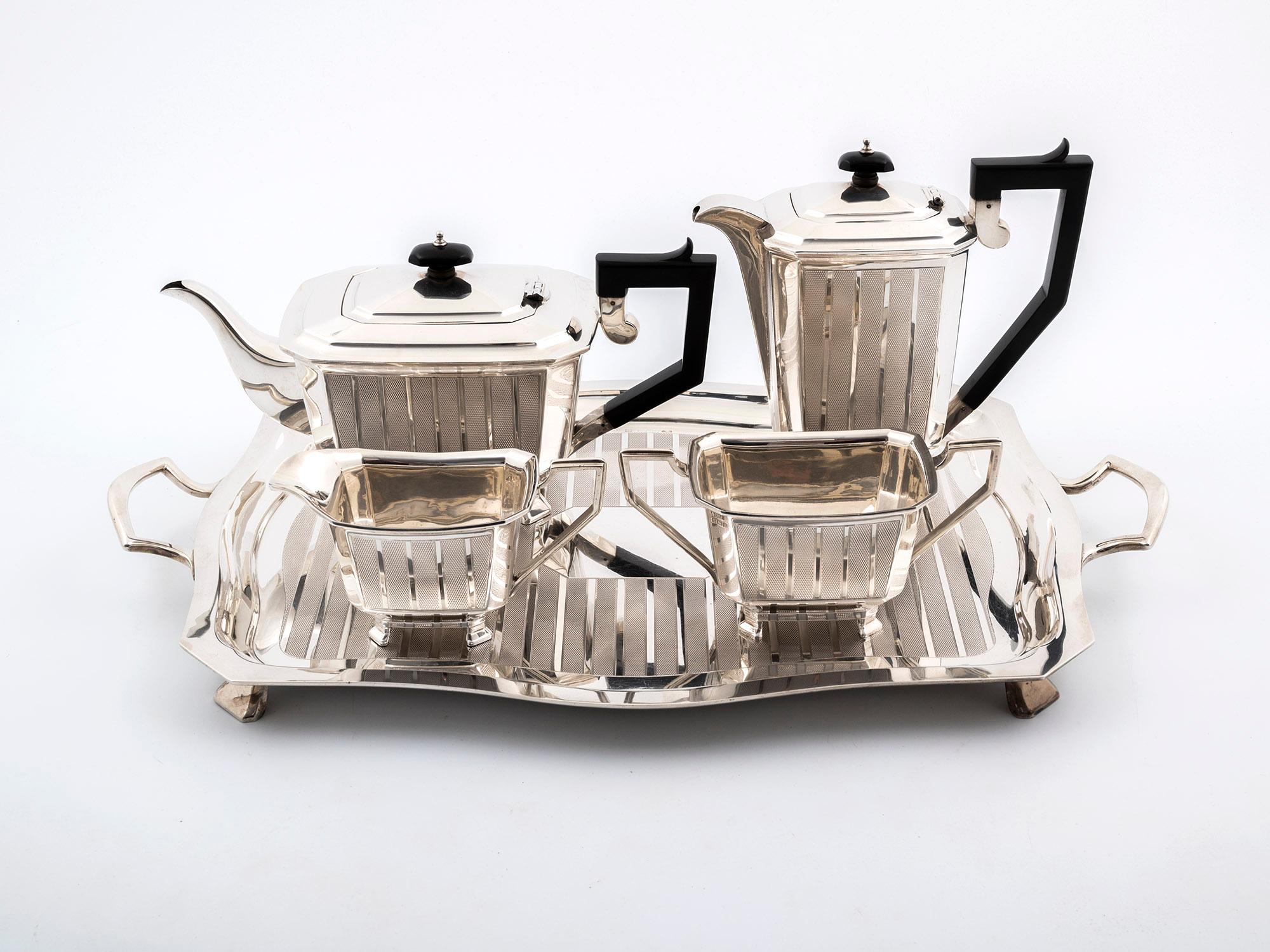 This radiant Sterling Silver five-piece Art Deco Tea Set by Birmingham Silversmith Charles Usher comprises a teapot, coffee pot, milk jug, sugar bowl and matching tray. Each piece has a clear hallmarks: 1932.

The teapot and coffee pot both have