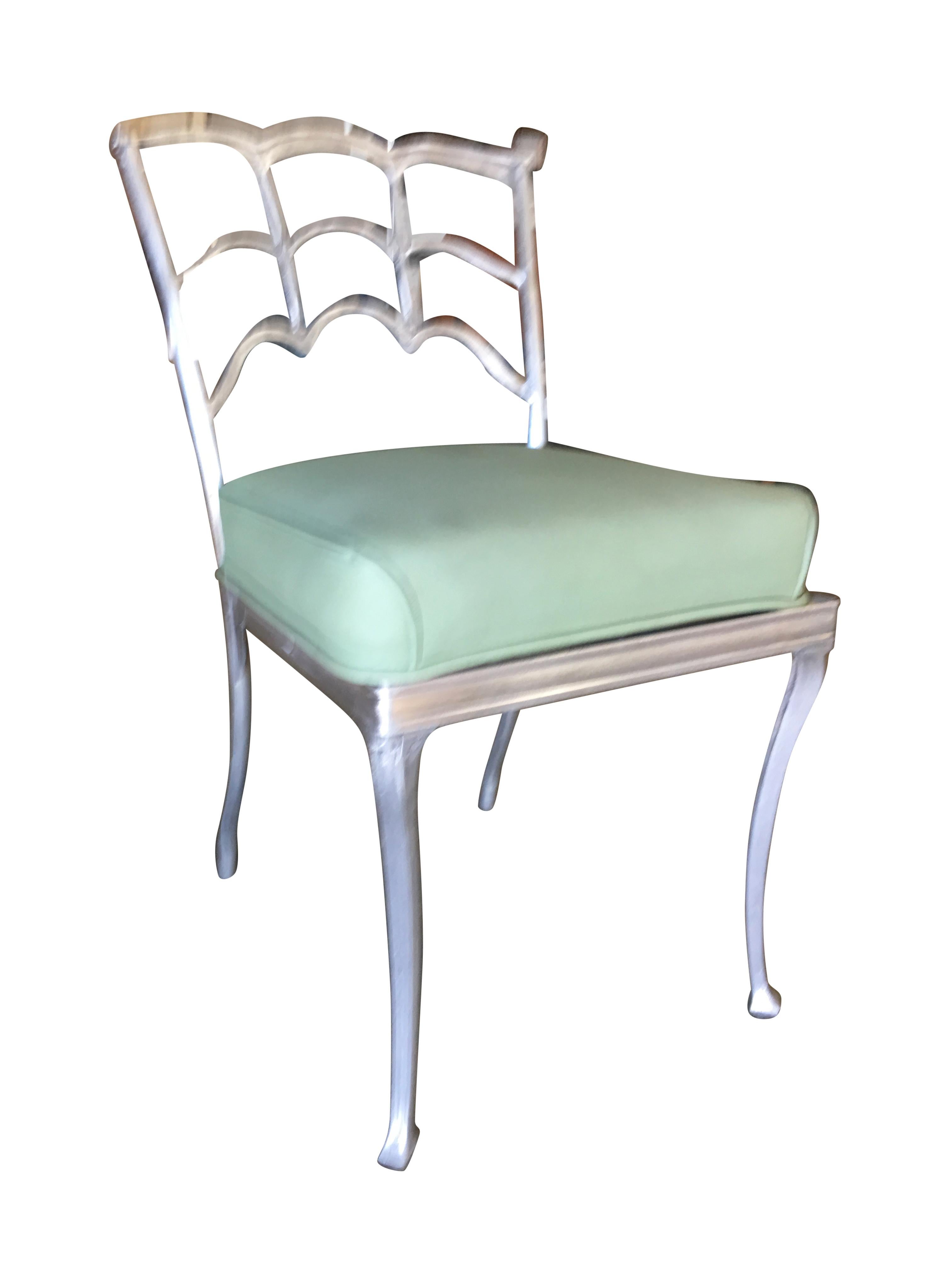 Pair of casted aluminum Art Deco dining side chair with a spiderweb back.