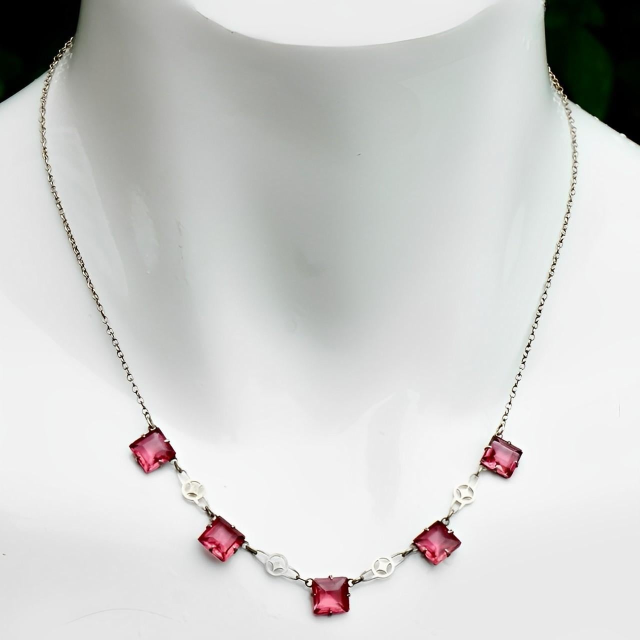 Art Deco silver tone chain necklace featuring beautiful square rouge pink crystals in open back settings, with ornate links. The faceted crystals are raised at the front and pointed at the back, for maximum sparkle. The chain links are soldered.