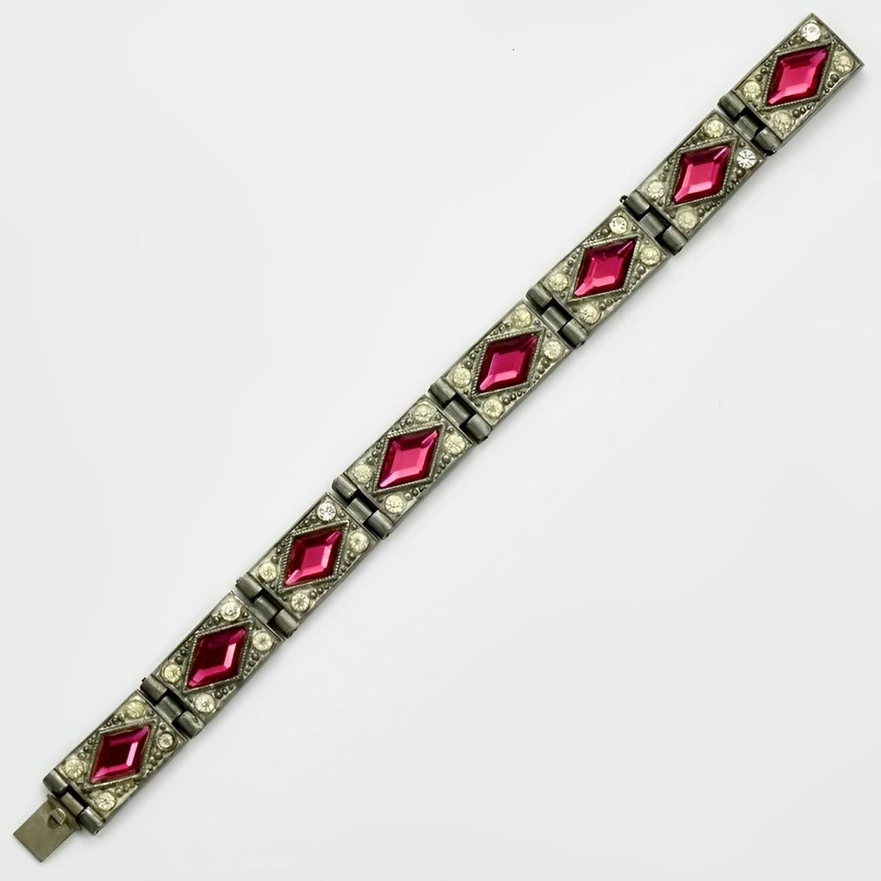 Beautiful Art Deco silver tone ornate link bracelet, featuring faceted pink diamond shaped glass stones surrounded by clear rhinestones. It is probably Czech. Length 15.9 cm / 6.25 inches by width 1.1 cm / .43 inch. The clasp works well. Some of the