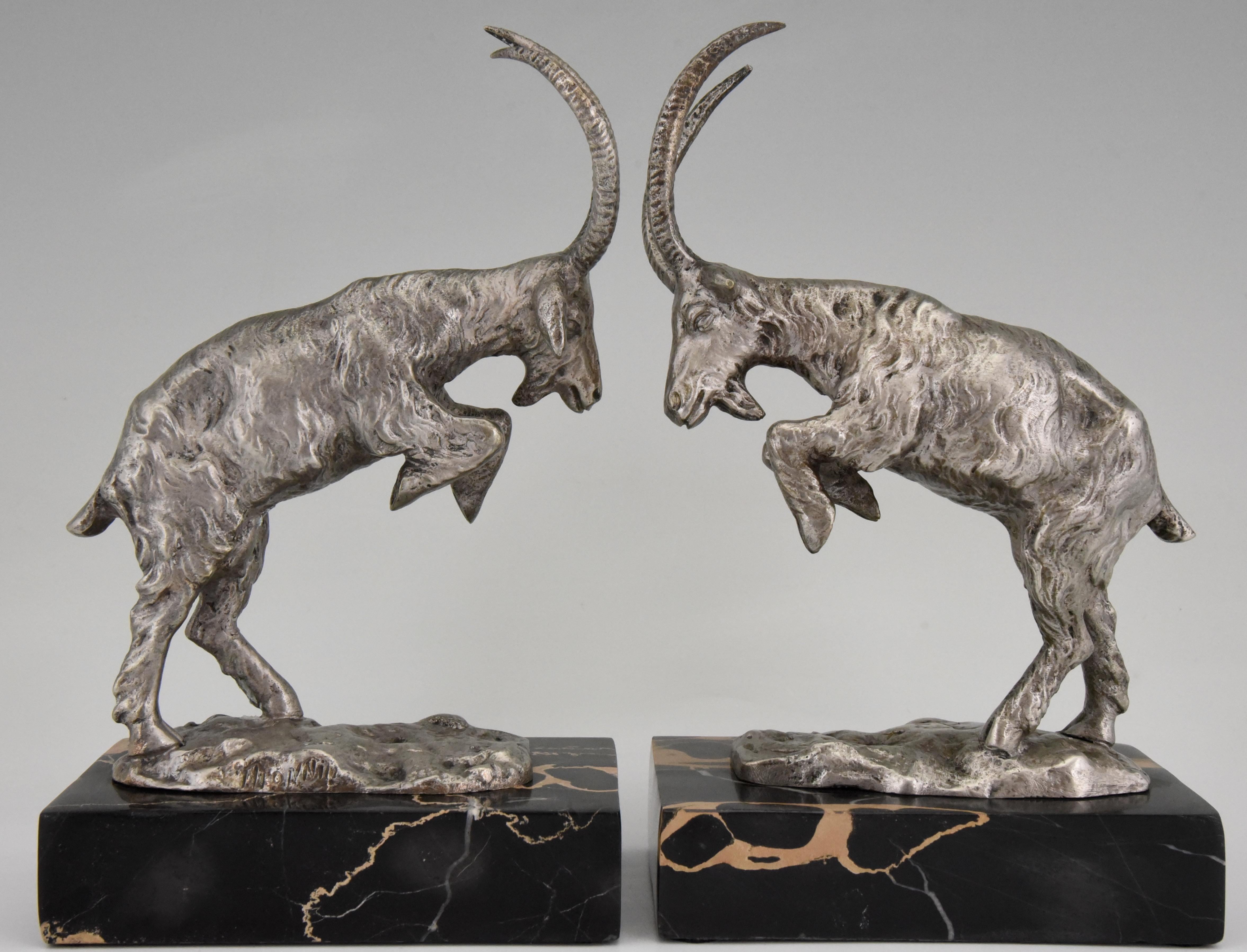 Nice pair of silvered bronze bookends with two long horned Billy goats, male goats. Signed by the French artist Monnin. The sculptures stand on Portor marble bases, circa 1925.