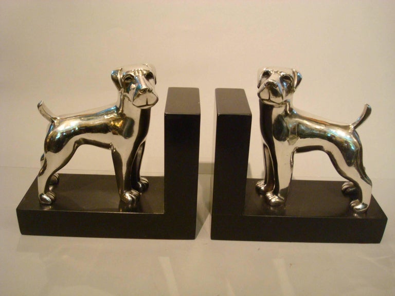 Art Deco bookends. A stylish silvered bronze figures of dogs by Ravas. The Breed of the dog looks like a Airedale Terrier, but not 100 percent sure.
Each dog is signed and numbered, one 21 and the other 22.