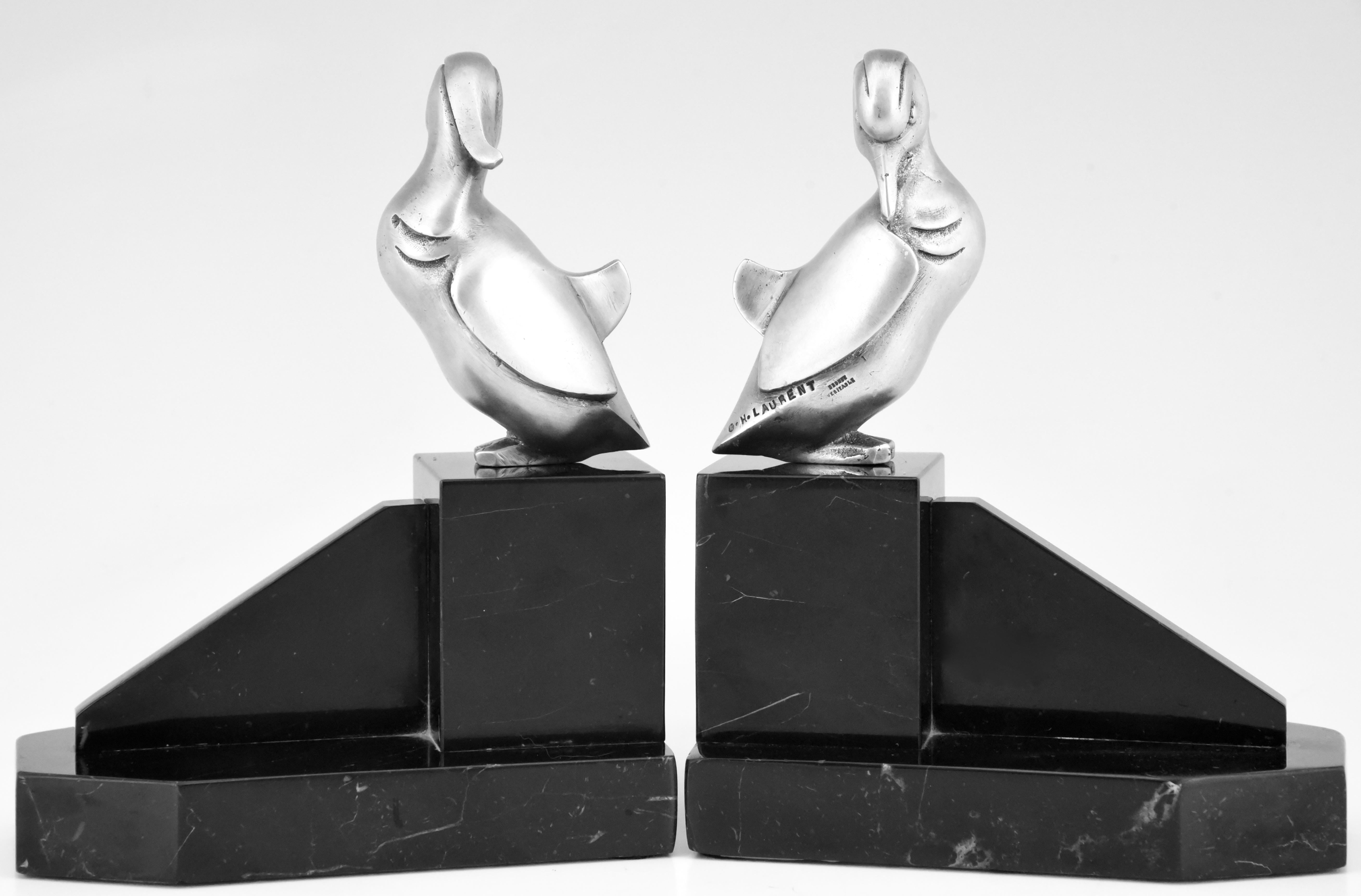 A lovely pair of Art Deco silvered bronze duck bookends on black marble bases. Signed by the French artist Georges H Laurent, circa 1925

Similar pairs are illustrated in the book:
“Art Deco and other figures” by Brian Catley. ??
General