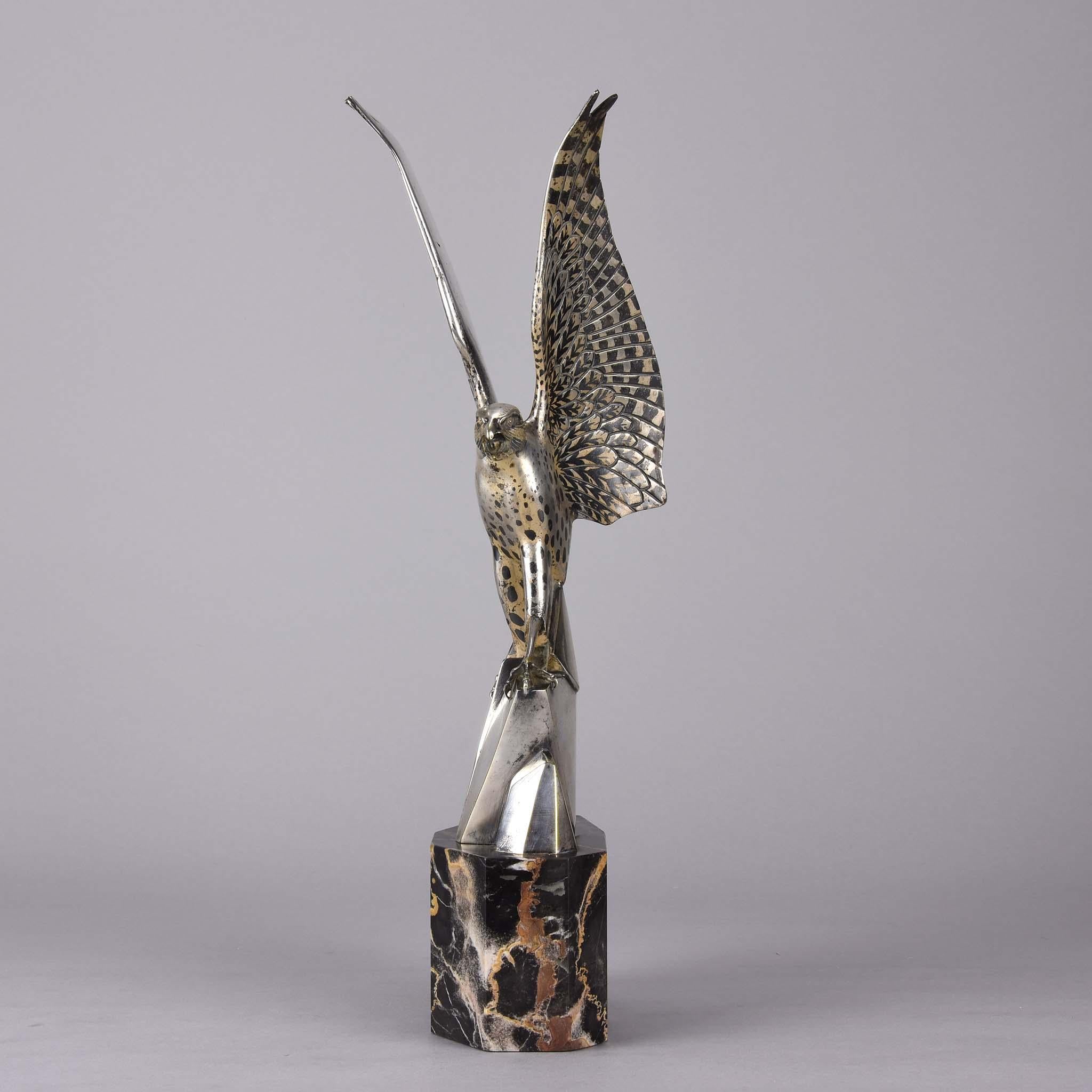 A wonderful early 20th century Art Deco silvered bronze figure of a falcon with wings raised and outspread, the surface highlighted with Niello decoration, chased with excellent surface detail, signed Rischmann to side of naturalistic rocky outcrop