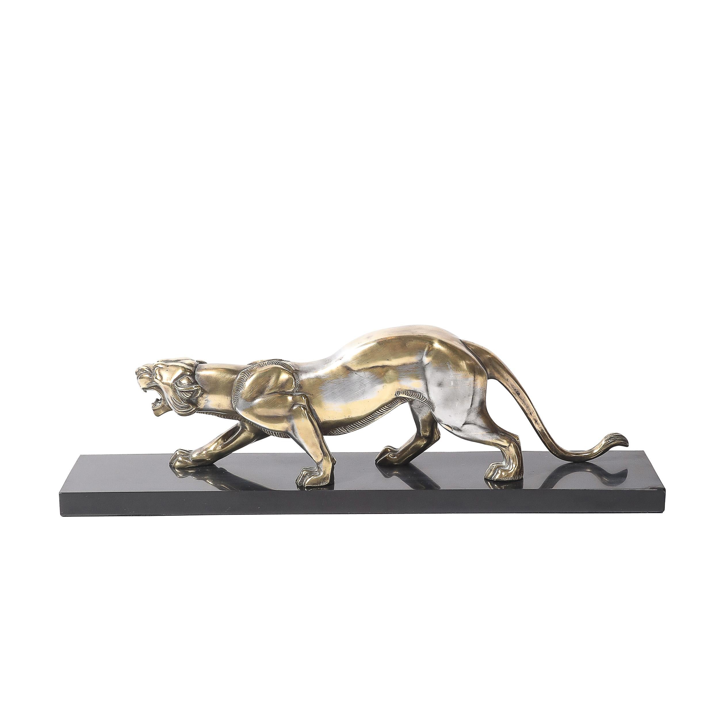 Cette étonnante sculpture Art déco, fabriquée en France vers 1930, représente un puissant lion en bronze argenté, incarnant l'énergie audacieuse et dynamique caractéristique du mouvement Art déco. Le lion finement détaillé capture un moment de force