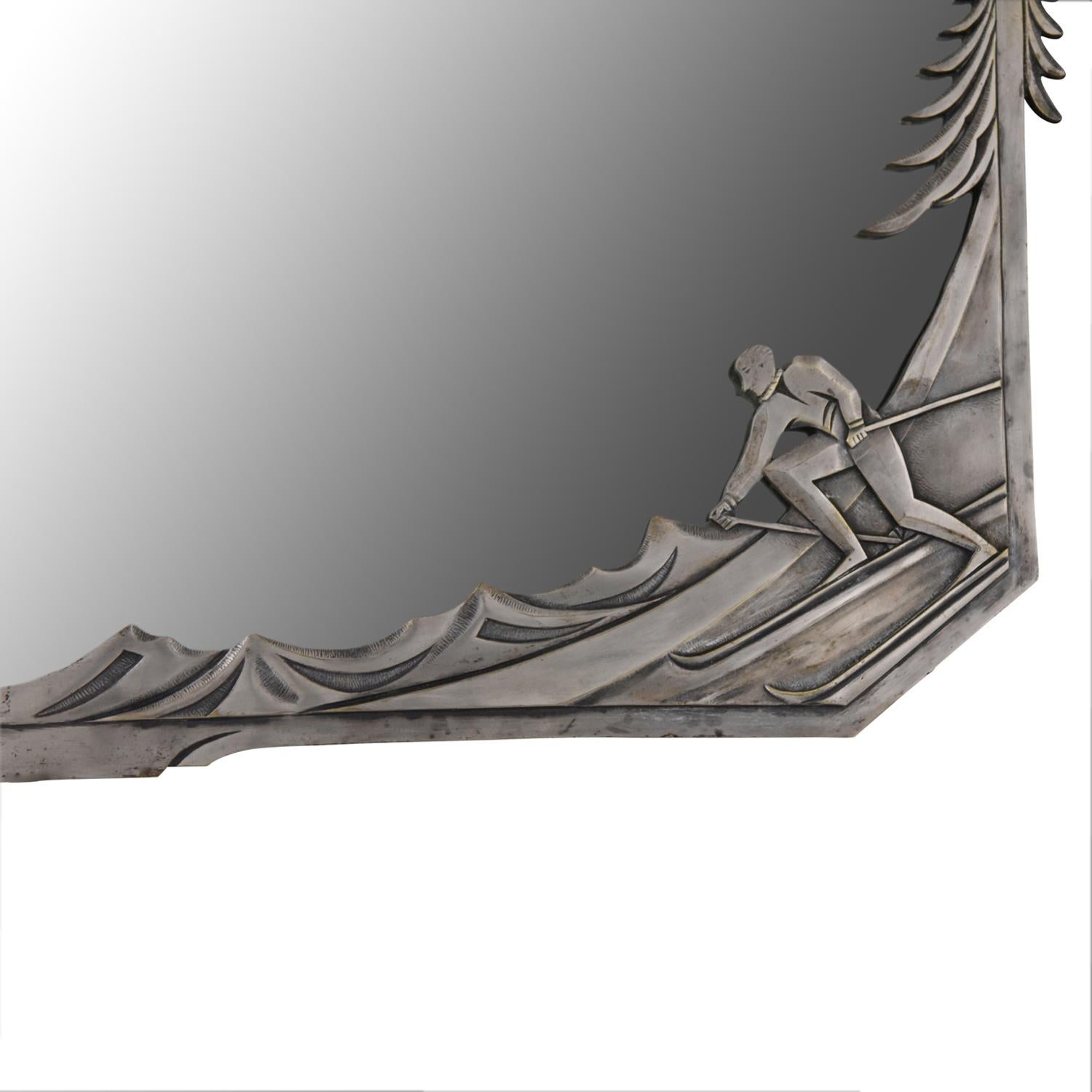 Very rare Art Deco silvered bronze mirror with a skier and a hiker taking a rest in the mountains with pine trees. Bevelled mirror glass.
 