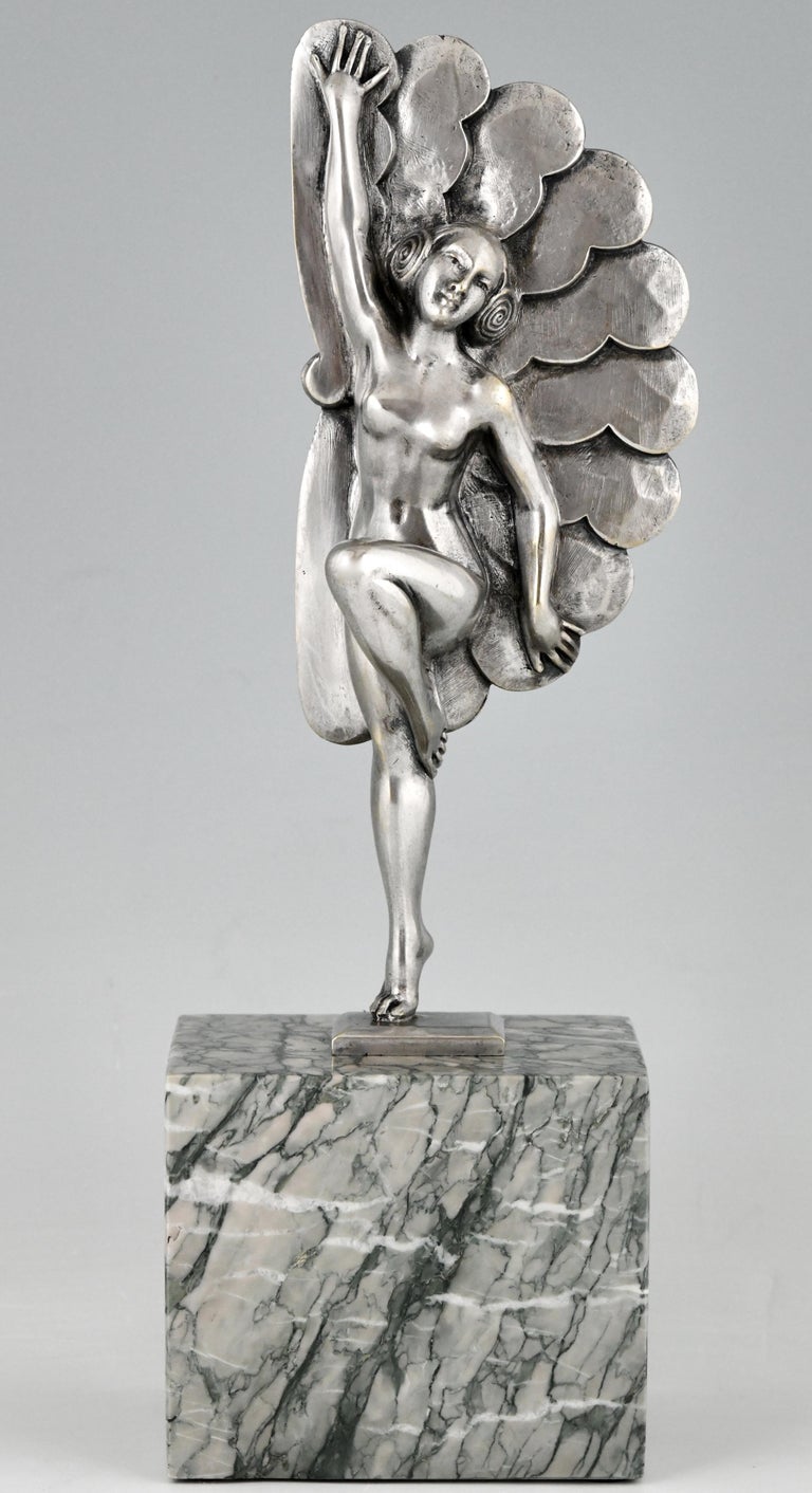 Art Deco sculpture in silvered bronze picturing a dancing lady with feathers. The bronze is signed by H. Molins and stands light green marble base, France 1925. 

“Art Deco and other figures” by Brian Catley, Antique collectors club. “Art Deco