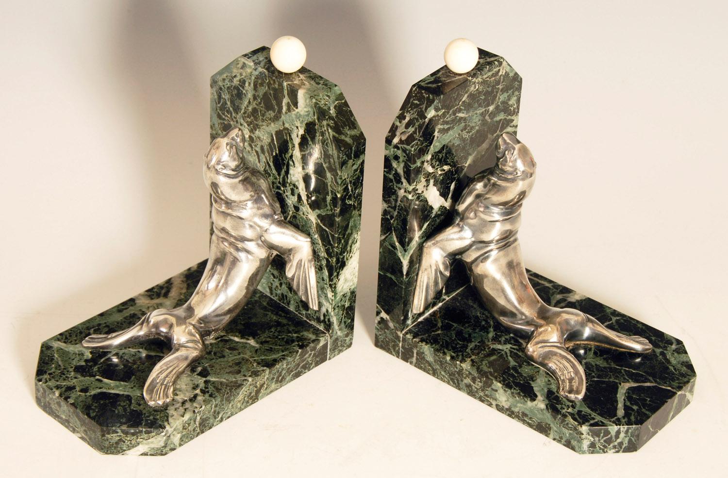 Large, heavy pair of Art Deco bookends by Maurice Frecourt, featuring silvered bronze sea lions / seals on green veined marble.
Weighing in at around 5.5 lbs each, these are very substantial bookends.

Price includes free shipping to anywhere in