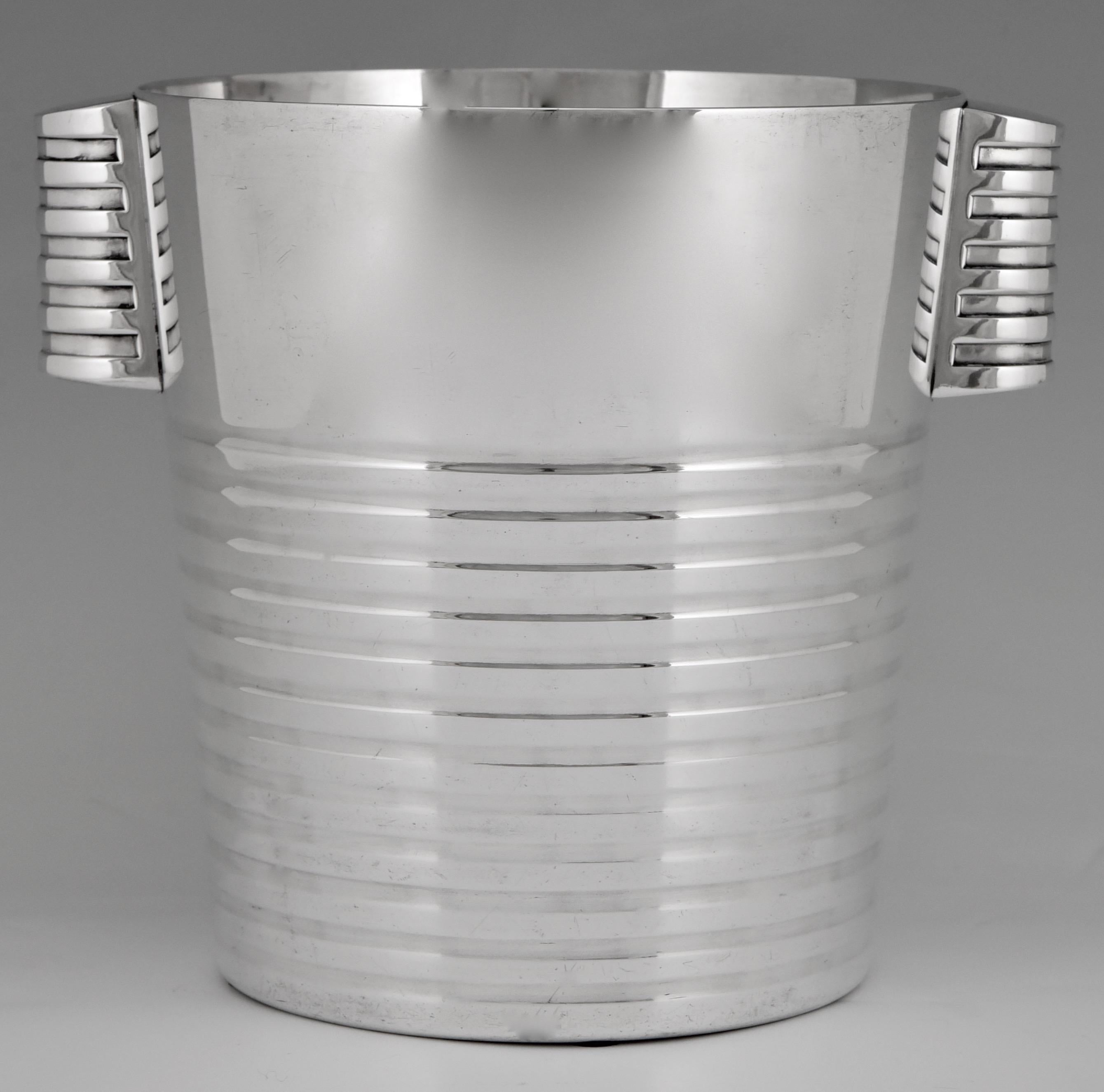 Stylish Art Deco silver plated champagne bucket designed by Luc Lanel for the Normandie, executed by Christofle, France, 1935. 

The champagne bucket is illustrated on page 69 of 
“The world of Art Deco”von Bevis Hiller for the Mineapolis