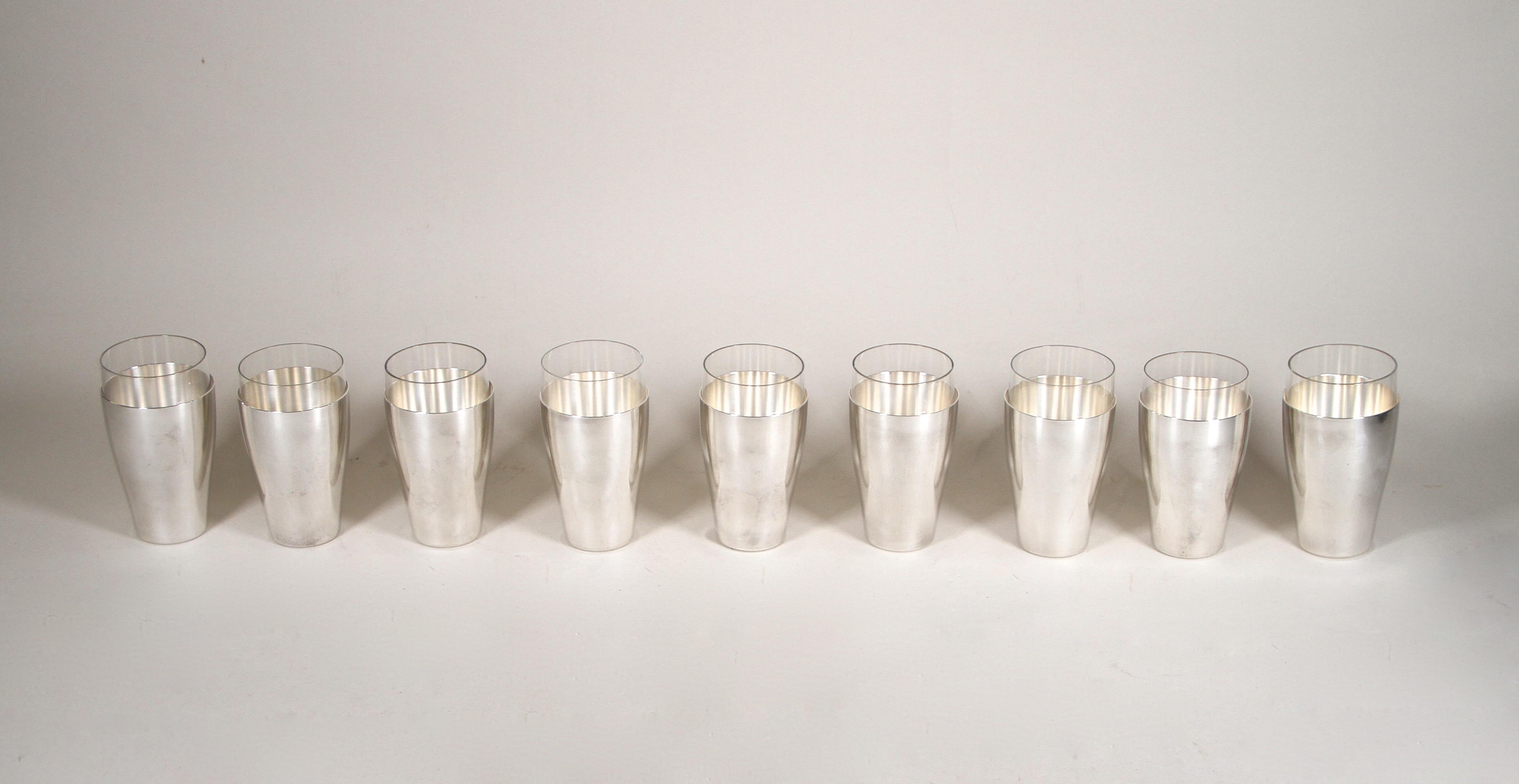 Marvelous set of nine silvered Art Deco Cocktail Glasses artfully made by the famous company of WMF in germany around 1930. These unique designed glasses consists of two parts: a great shaped, silvered brass covering and an extraordinary inserted