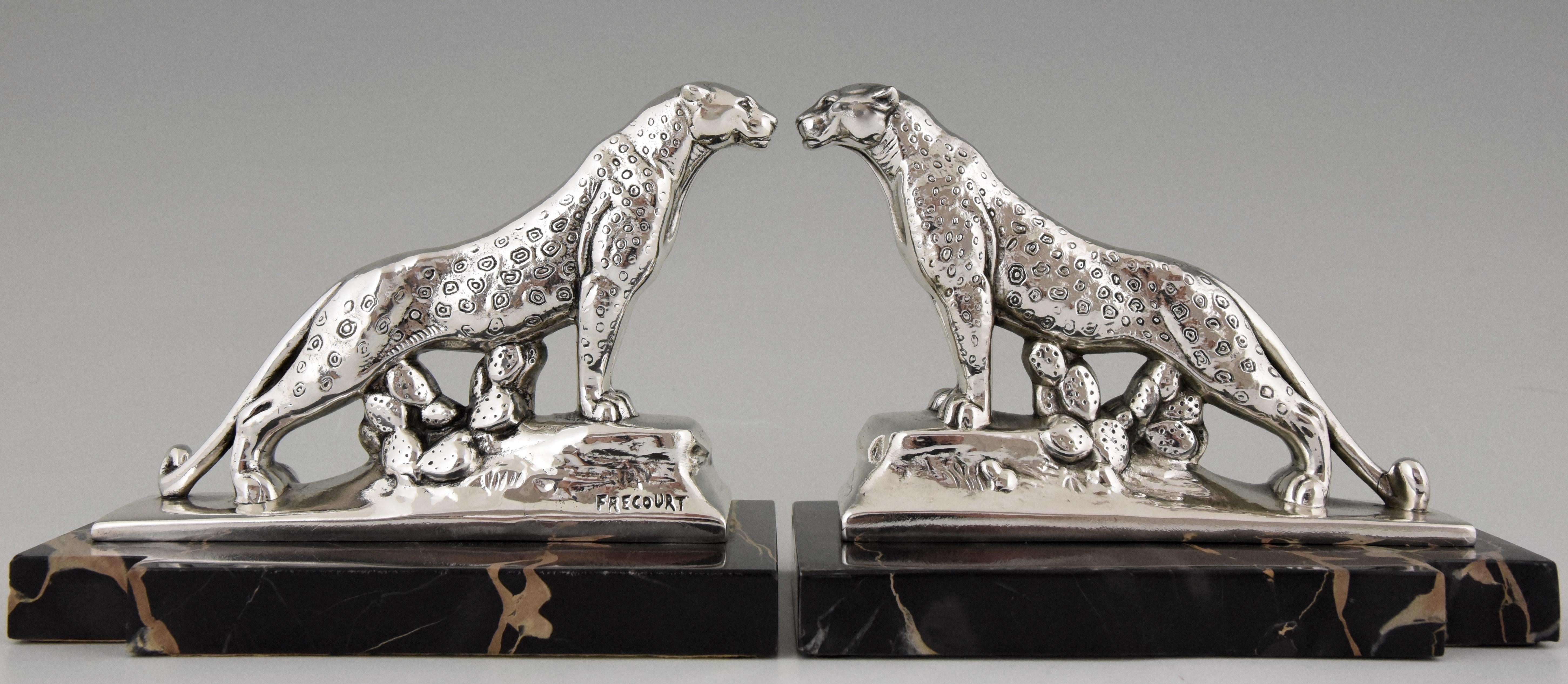 Stylish pair of Art Deco silvered panther bookends signed by the French artist Maurice Frecourt, circa 1930. The sculptures are mounted on fine Portor marble bases.