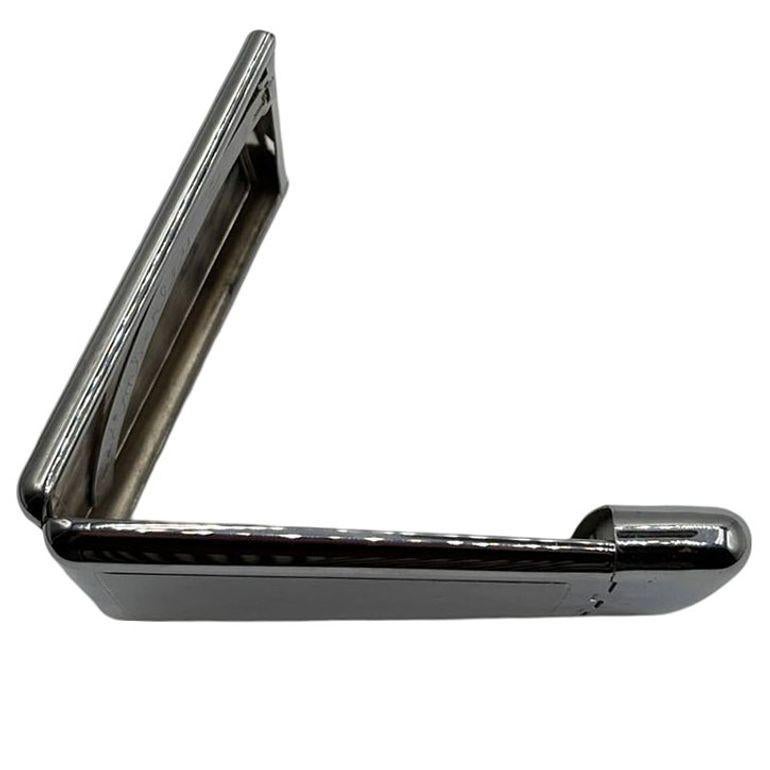 This elegant cigarette case combines form and function with classic Art Deco styling. The case features engraved details inside, with 