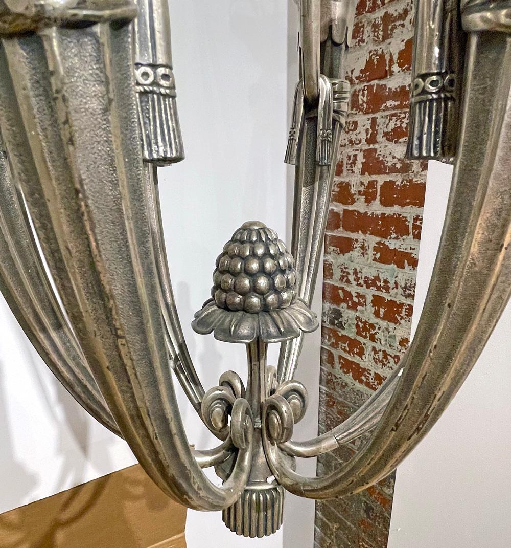 Beautifully finished in silvered bronze, with an attenuated shape and curving silhouette that reflects high style Art Deco in 1920s France, this sophisticated and lovely chandelier is a rare survivor. The shape and elegance of the chandelier shows