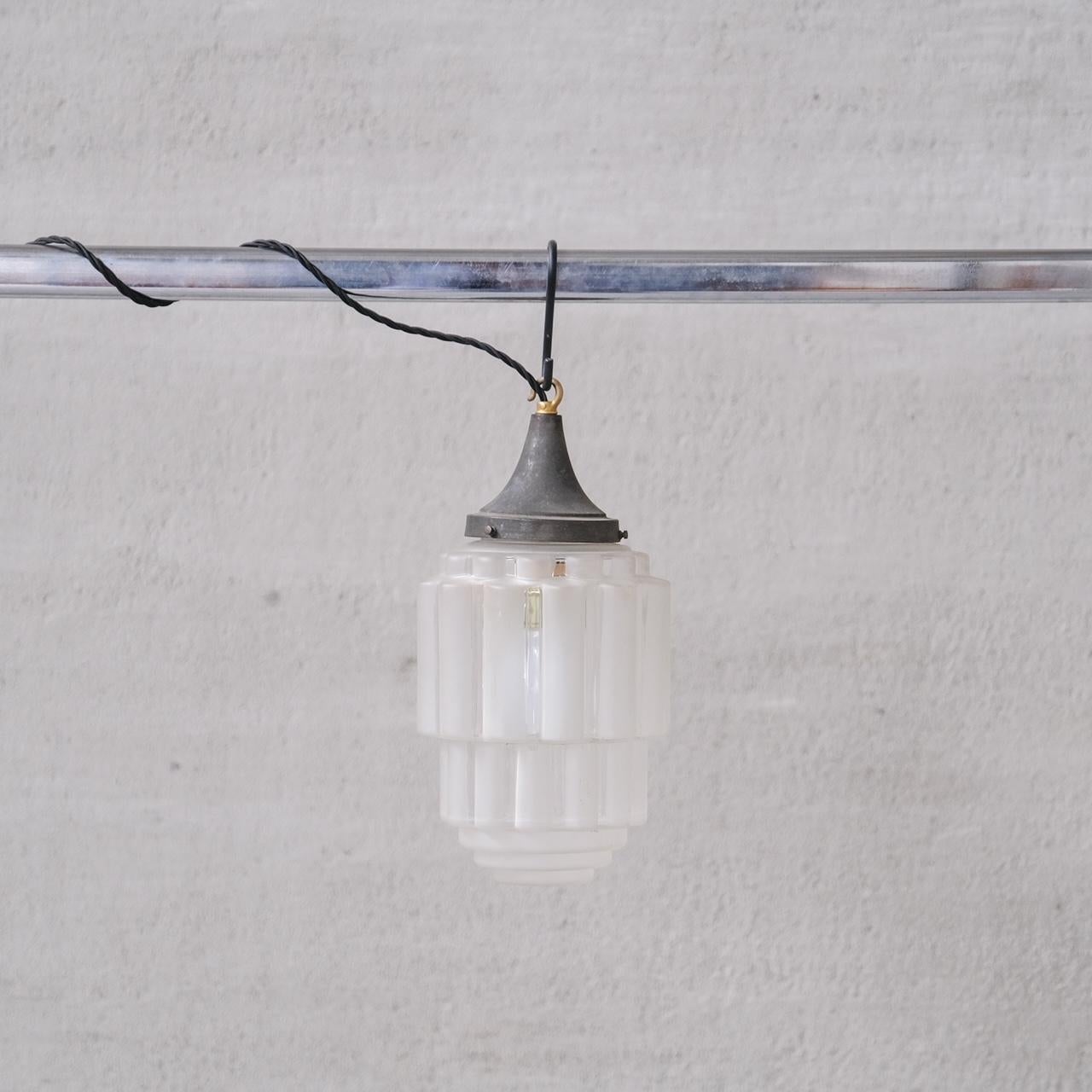 A two tone, clear and opaque glass pendant light, often labelled as 'sky scraper' pendants.

France, c1920s.

Stepped design.

No chain or rose was retained, however they are easy to source online.

Good vintage condtion, re-wired and PAT