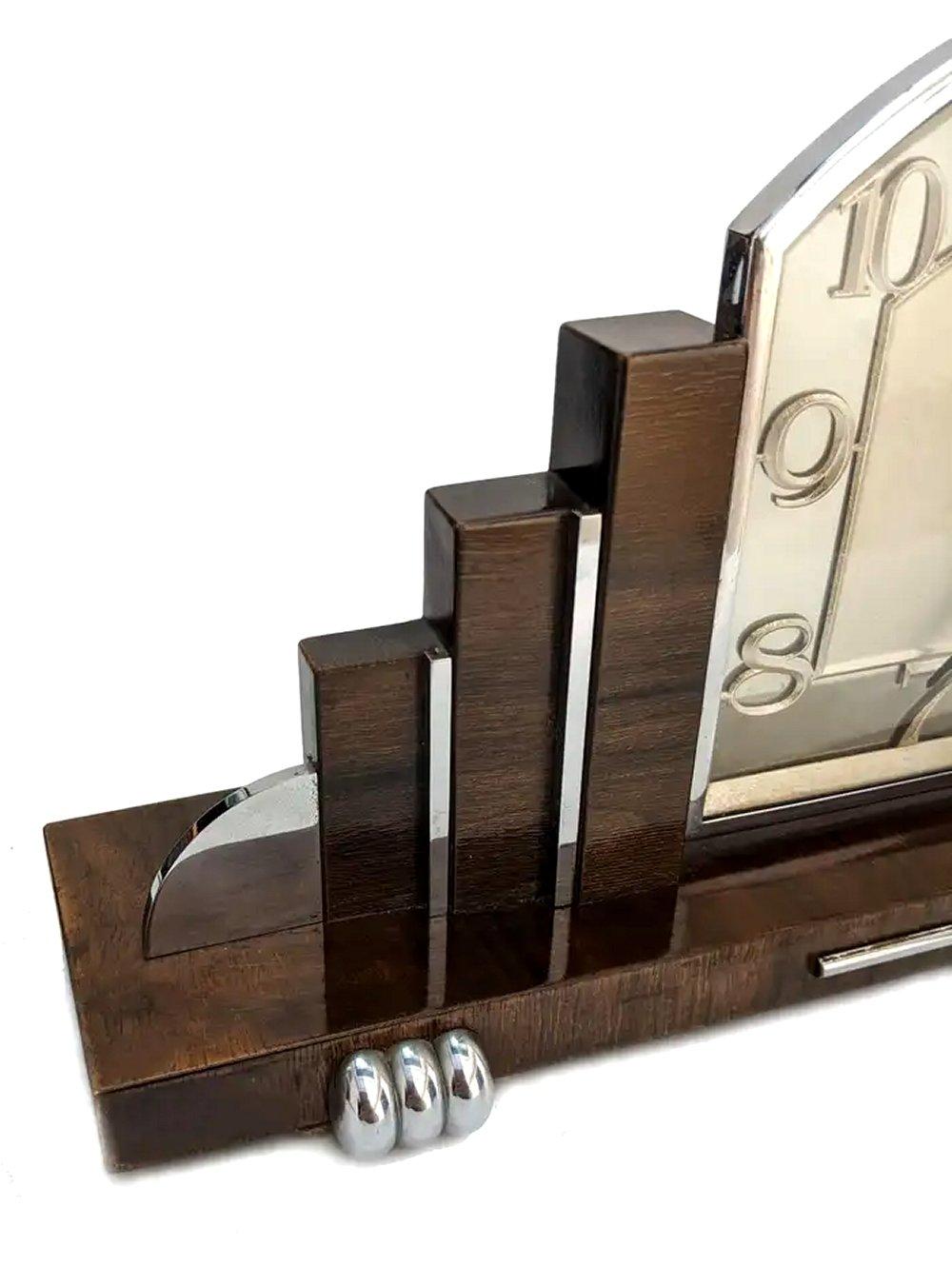 For your consideration is this very stylish 1930s Art Deco eight day wind up mantle clock made in England. Highly desired skyscraper stepped outline, a shape that is iconic to the 1930's and New York skylines . Made from Walnut with chrome accents