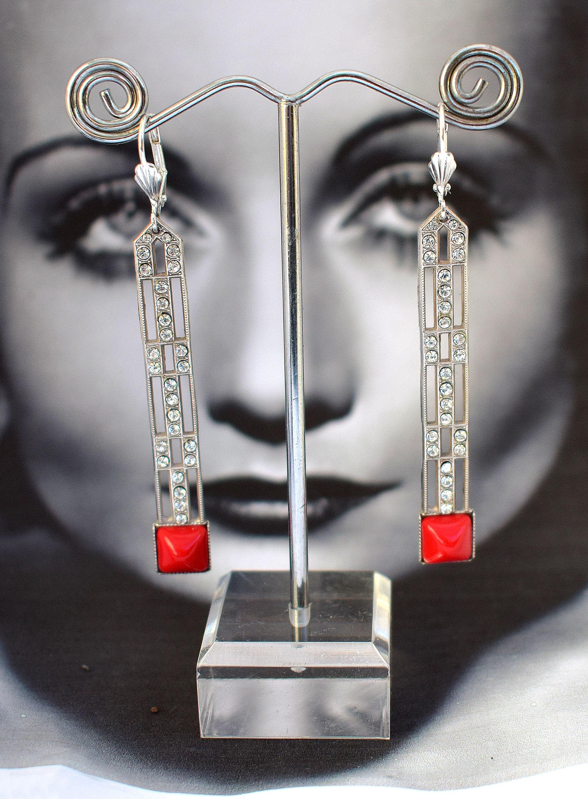 Beautiful pair of Art Deco Style earrings . These earrings are made from silver plated brass and red glass and are in excellent condition. The detailing and craftsmanship is superb. All of our Art Deco Style Jewellery and watches are sent out