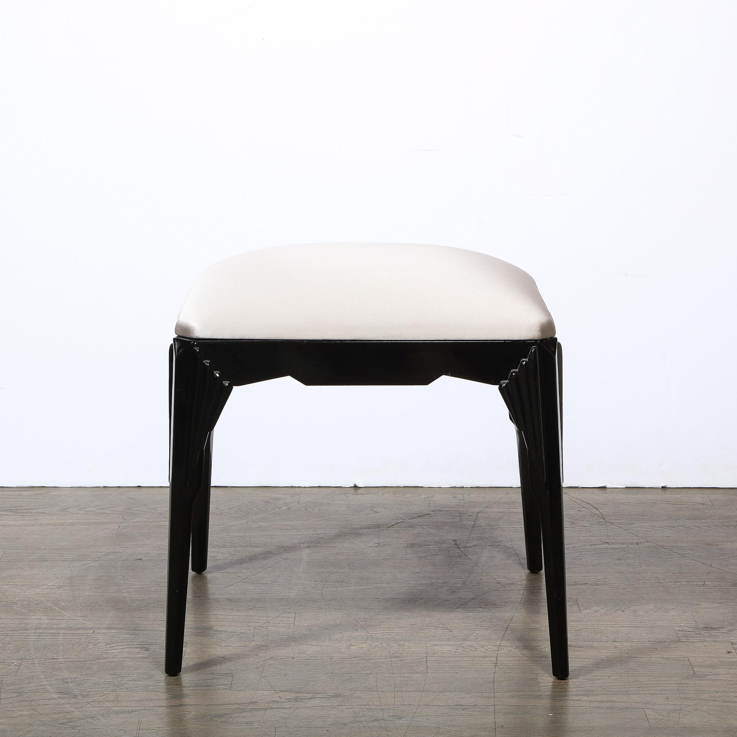 This stunning Art Deco Skyscraper style stool was realized in the United States circa 1935. It feature subtly splayed legs with cubist skyscraper style detailing- composed of adjoining tiered and staggered geometric forms- at each corner connected