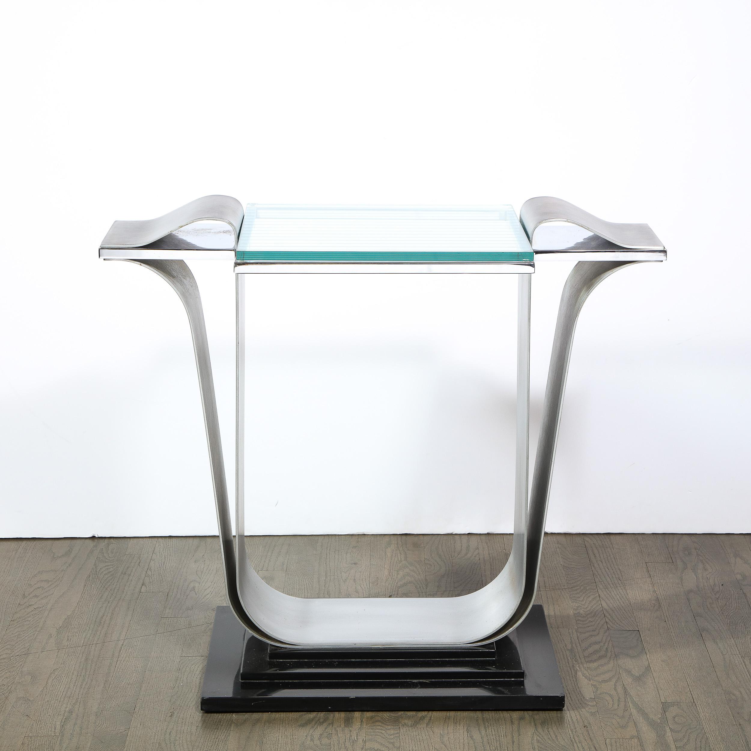 This elegant and dynamic Art Deco revival console table was realized in the United States circa 1080. Sitting on a black lacquer skyscraper style stand the console is support by two undulating stylized s-form supports that curve under the glass