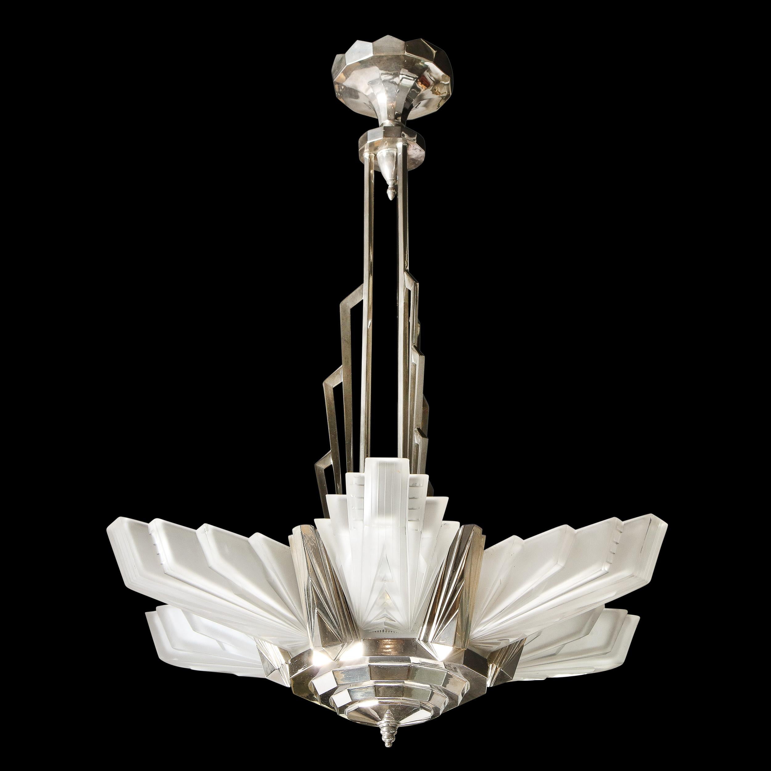 A stunning and rare example of a fine French Art Deco chandelier by Atelier Petitot. This piece exemplifies the height of the Skyscraper influence on Art Deco in France. It features six glass shades in a highly stylized Cubist design each signed