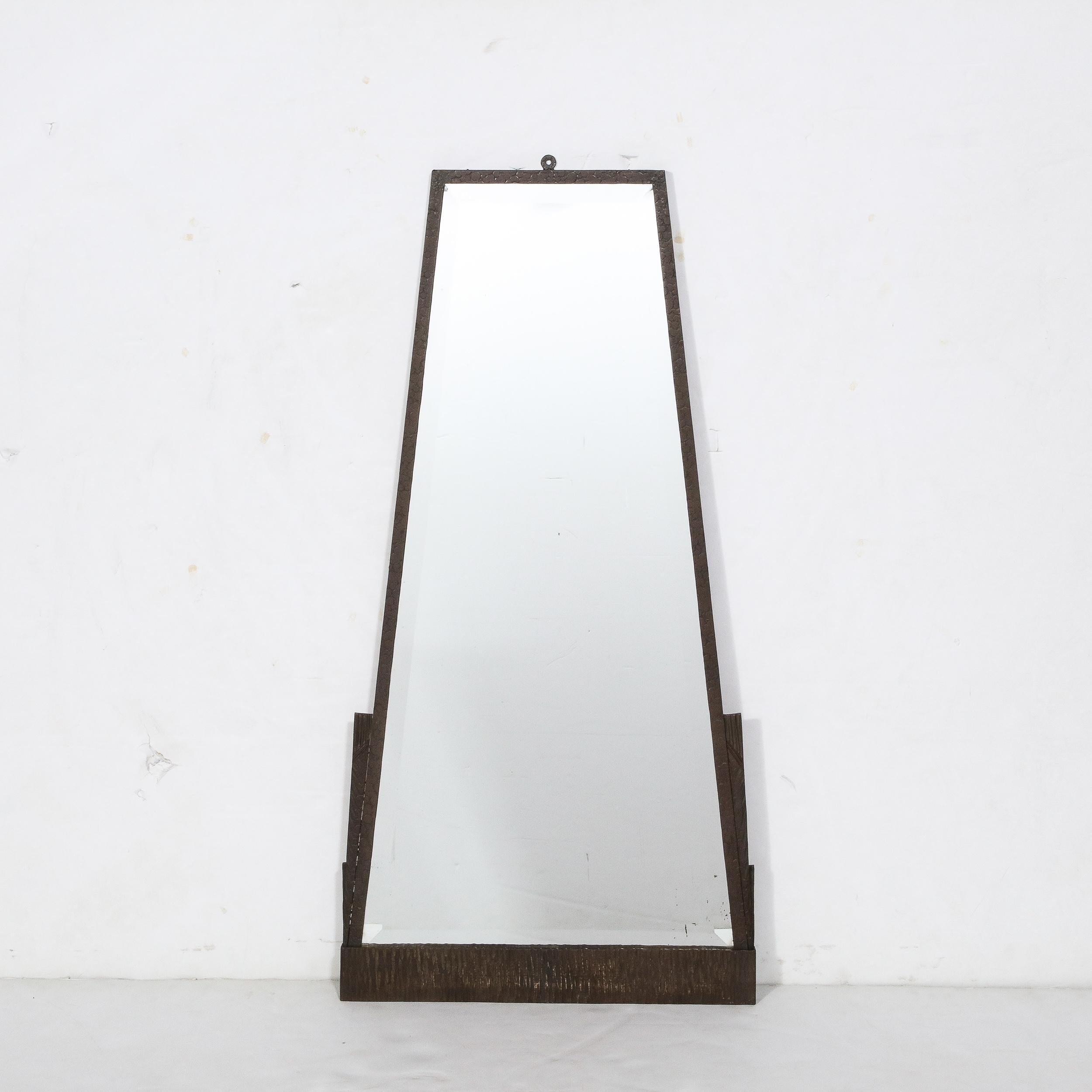 This bold Art Deco Skyscraper Style Pyramidal Mirror in Oil Rubbed Bronze originates from the France , Circa 1935. Featuring a carefully scaled geometric frame in Solid Bronze, the framework is widest at the base with stepped skyscraper detailing