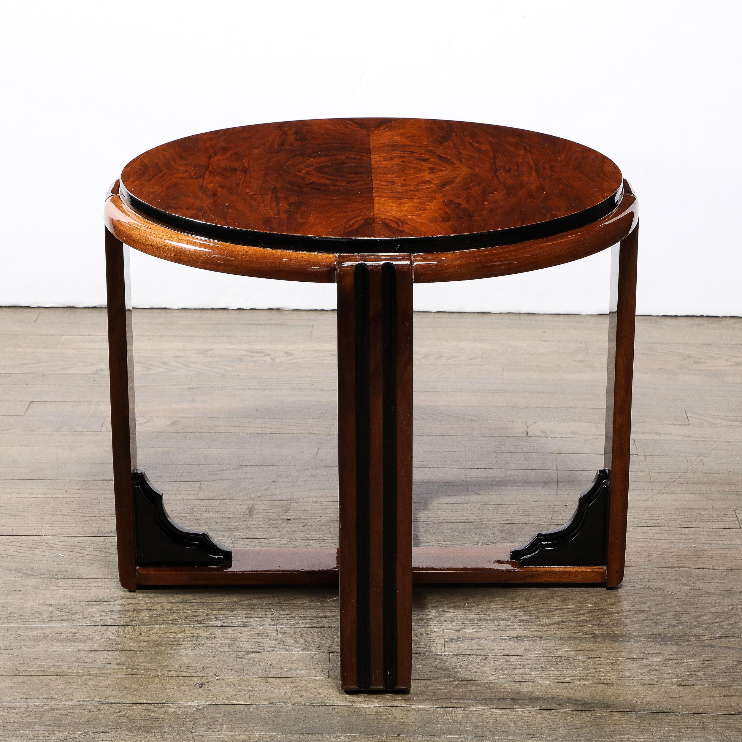 This elegant Art Deco Machine Age skyscraper side/ occasional table was realized in the United States circa 1935. It features a two skyscraper style top in burled walnut (showcasing a dramatic natural woodgrain) with a slightly inset center banded