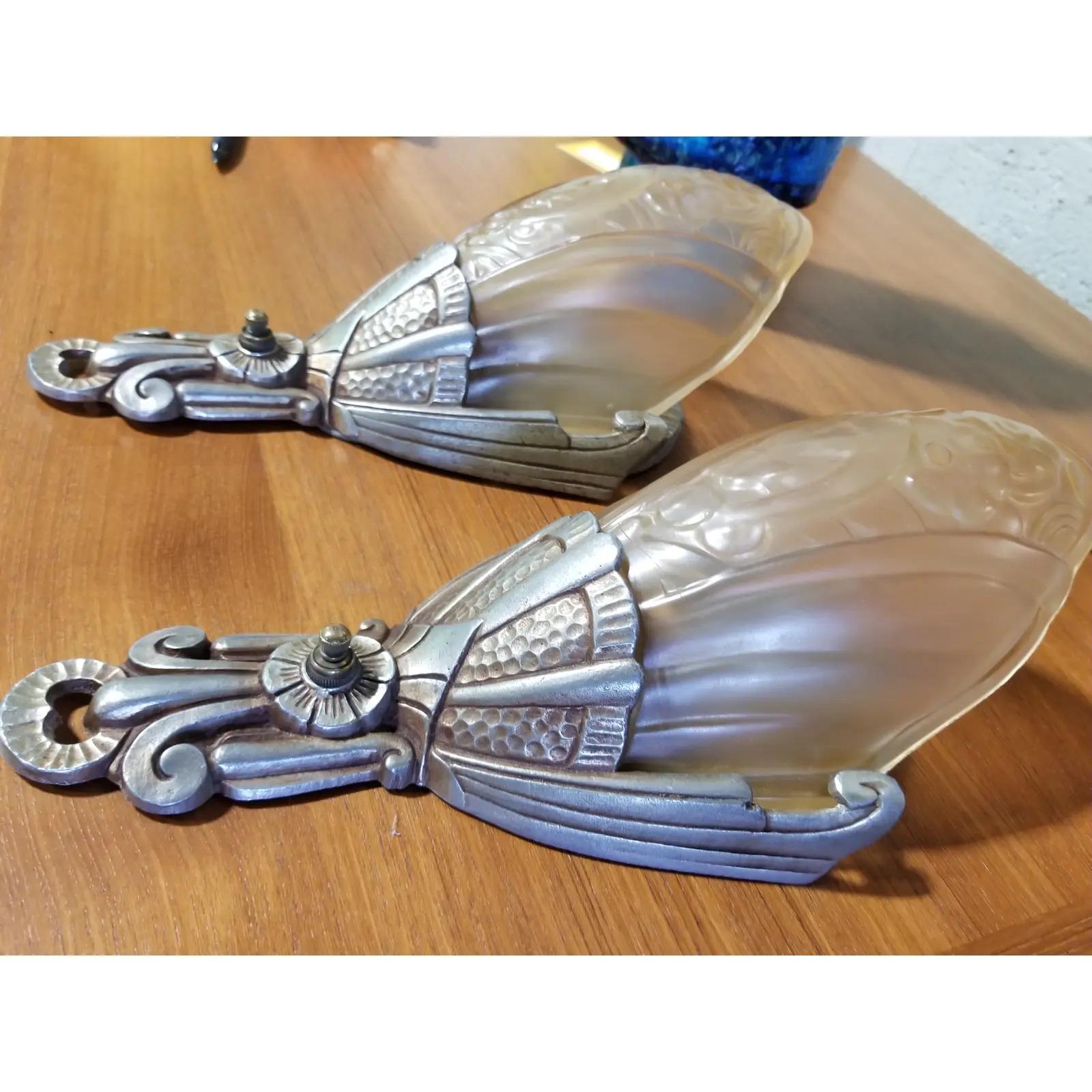 A pair of 1930s Art Deco wall sconces by Lincoln Lighting Company. Cast aluminum back plates with satin glass pressed glass shades. Original working condition. Each light has on/of switch. Excellent original condition.