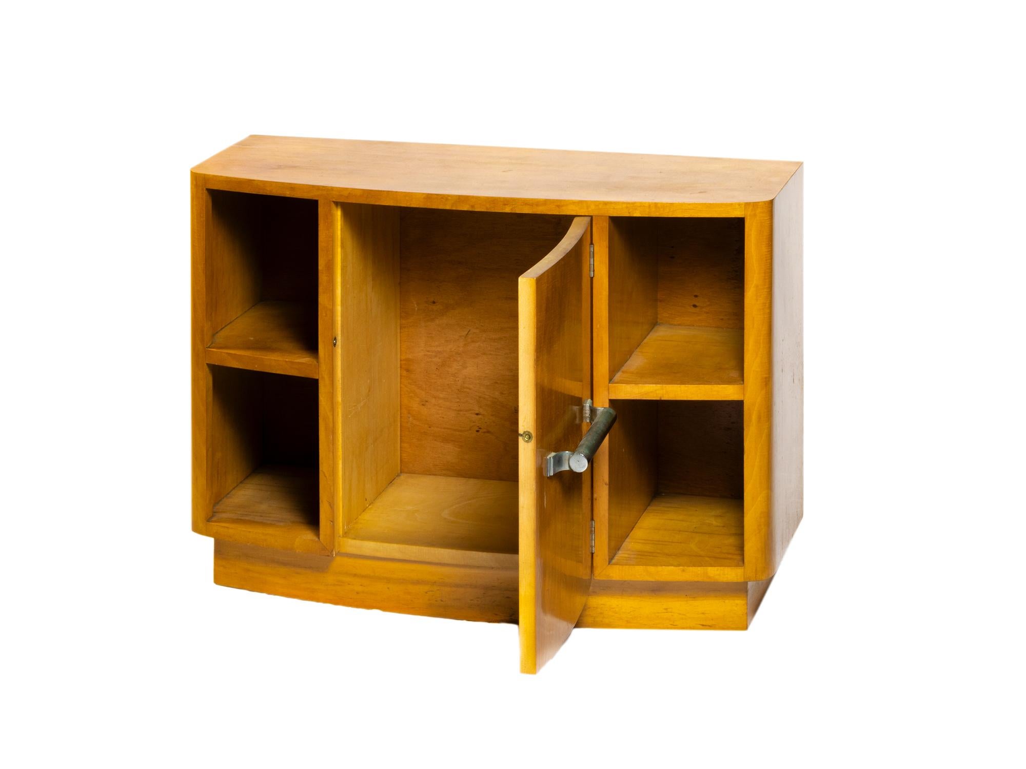 An elegant spruce wood light color support piece with four bookcases and a large door. 
Small piece with tin hardware.
Order, color, geometry, words that define the Art Deco world.
In Portugal examples like this one were created for refurbishing the