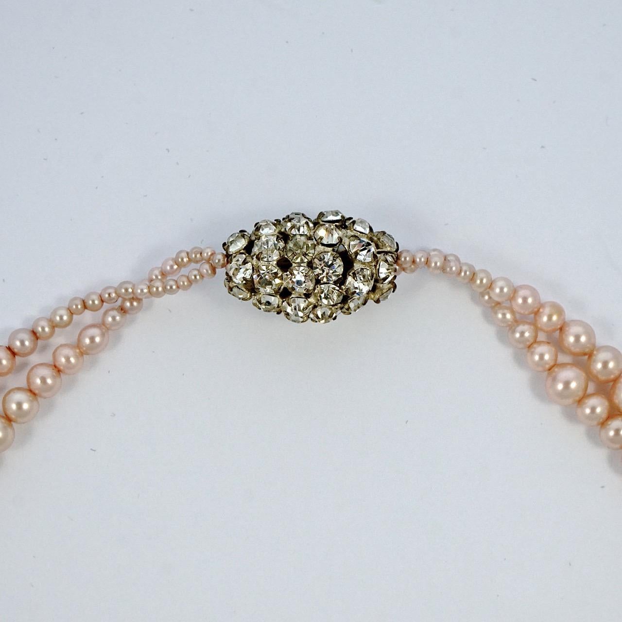 Art Deco pale pink faux pearl sautoir necklace featuring a beautiful rhinestone bead. This is a small necklace when fastened, though the length is adjustable. The necklace measures a total length of 49cm / 19.3 inches. The necklace is in very good