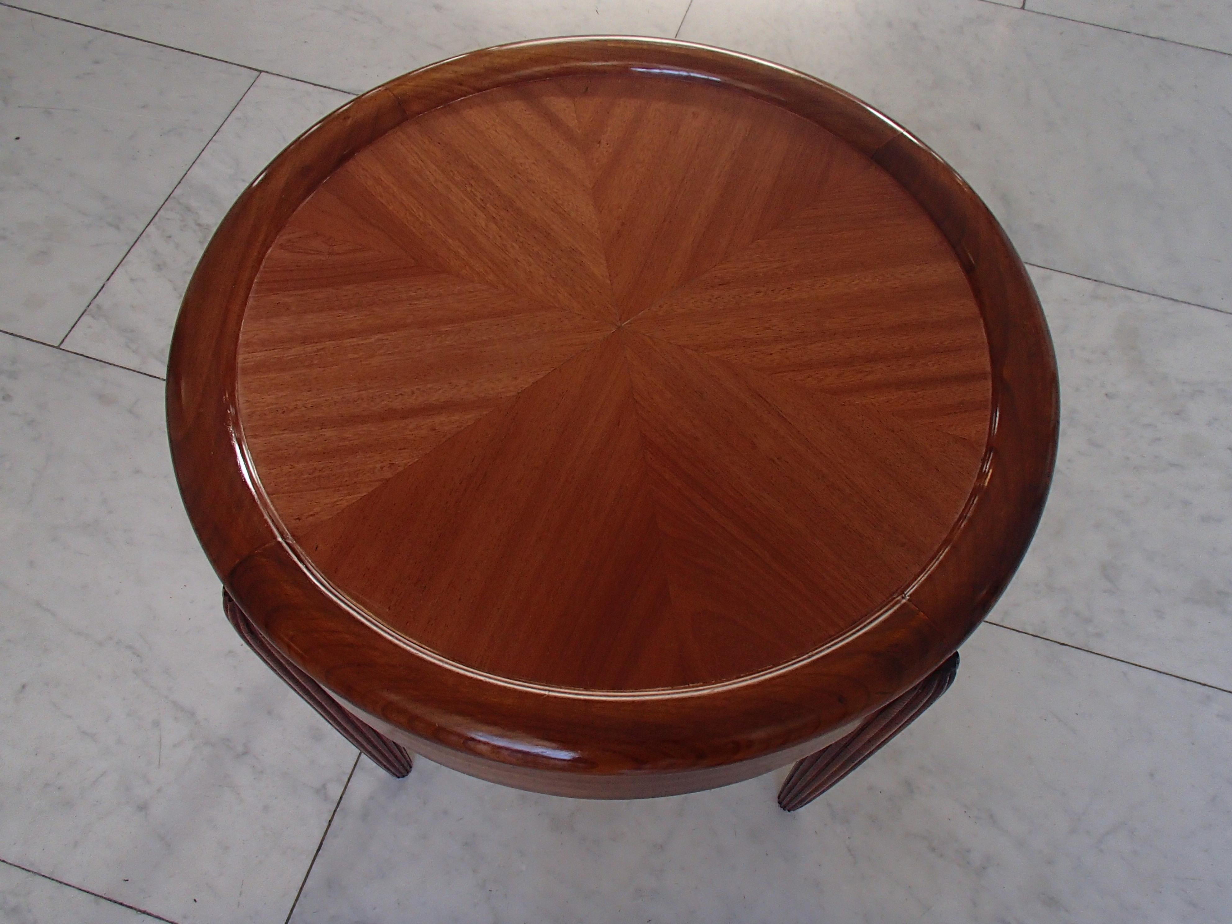 Art Deco small round full mahogany table with carfed legs.