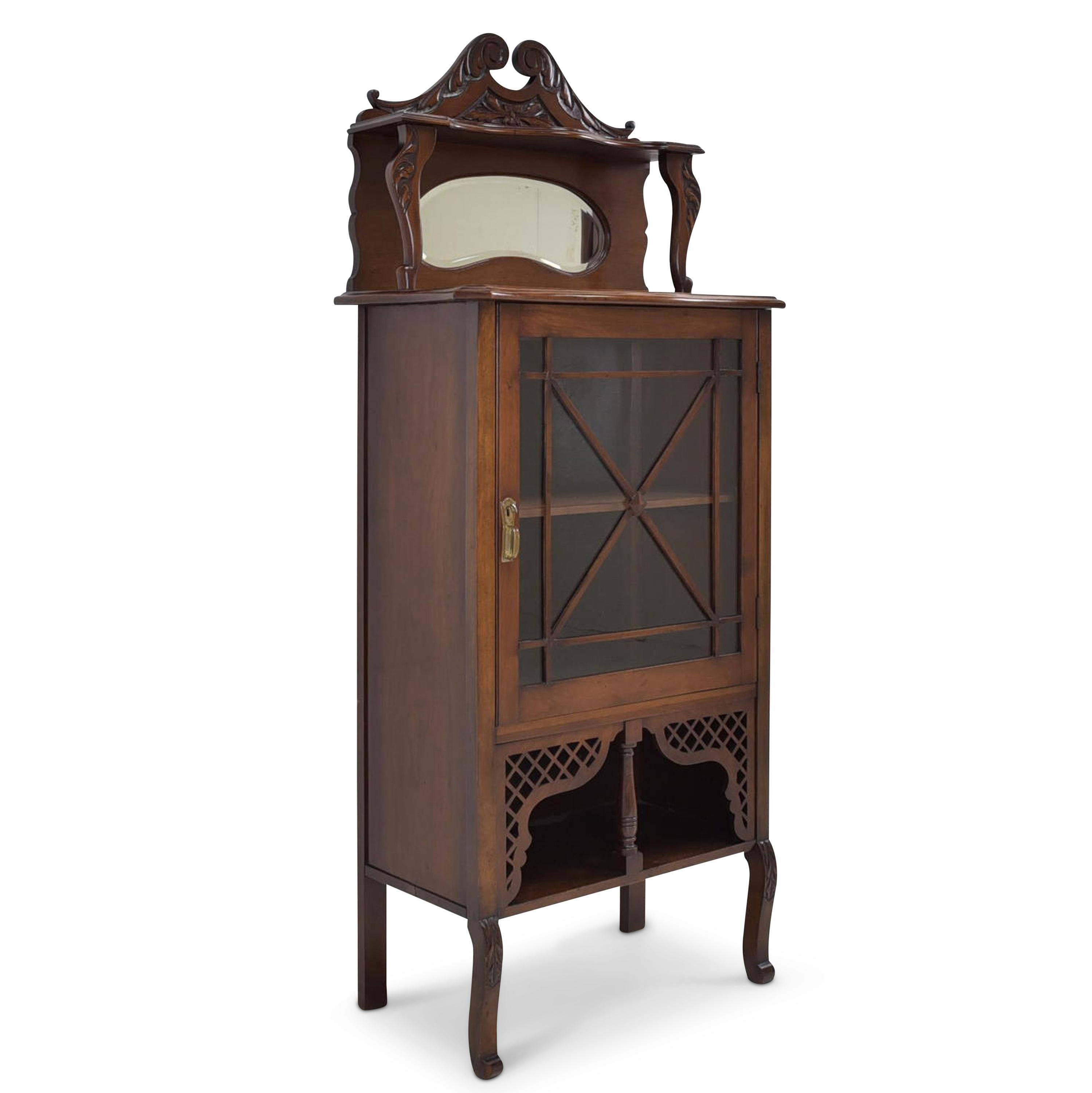 Small showcase restored Art Deco around 1930 walnut narrow

Features:
Mostly solid walnut
Single-door model with one shelf and open compartment, mirror and shelf on top
High quality
Beautiful carved decor and decorative elements
Original