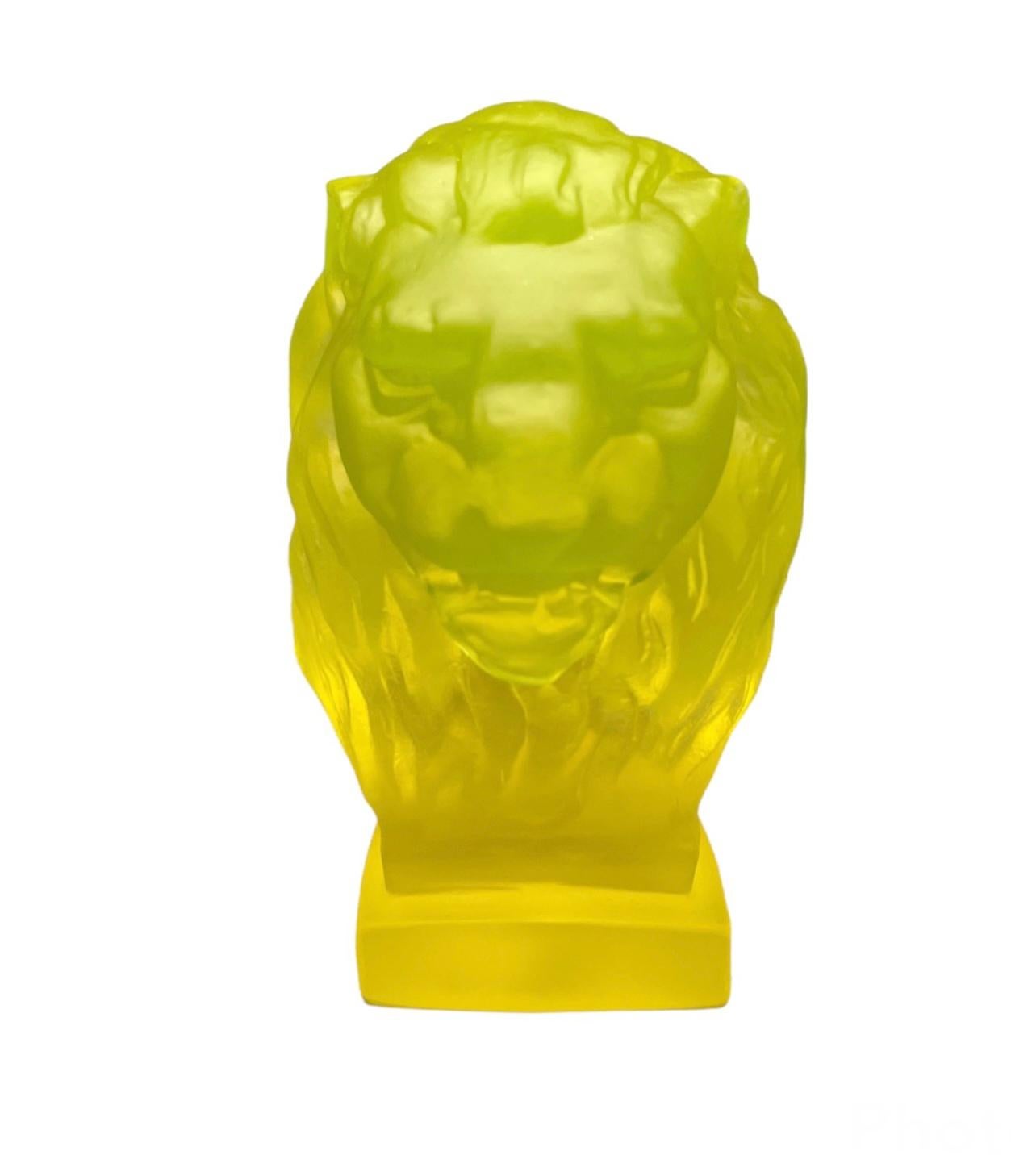 This is an uranium glass small head lion bust. It depicts the sculpture of a yellow hairy head lion.