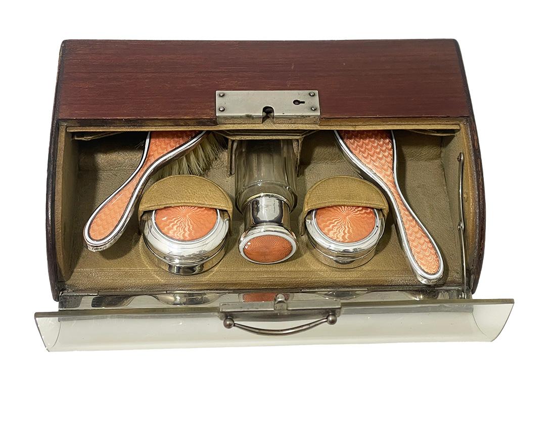 Art Deco small vanity guilloche dressing table set, 1920

A fantastic collector's item, possible for doll enthusiasts from the early period of the 20th century. An Art Deco vanity set cased in a wooden cherry colored display box with a round glass
