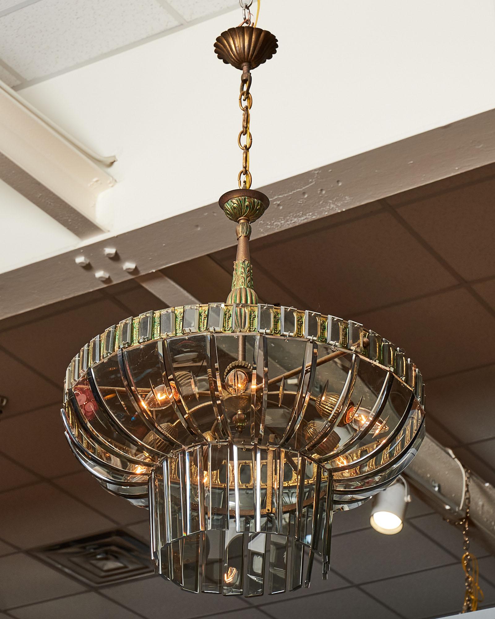 A rare Italian chandelier from San Remo, Italy, by designer “extraordinaire” Lucaino Frigerio (1928-1999). This chandelier features a combination of hand cut square glass and tapered glass components. The fixture is also adorned with finely cast