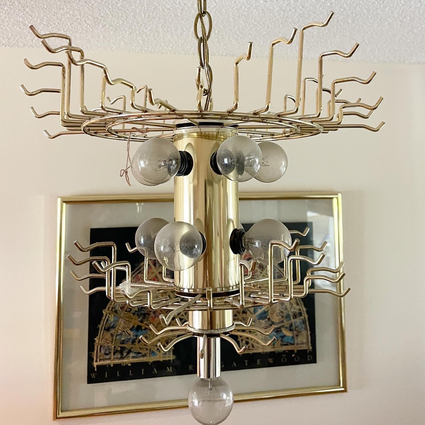 Exceptional vintage art deco lucite chandelier. Features alternating hangin pieces of lucite from clear to gold which appear as smoked when lit. Has 10 lights, 5 on top tier, 4 in the middle and one at the bottom.